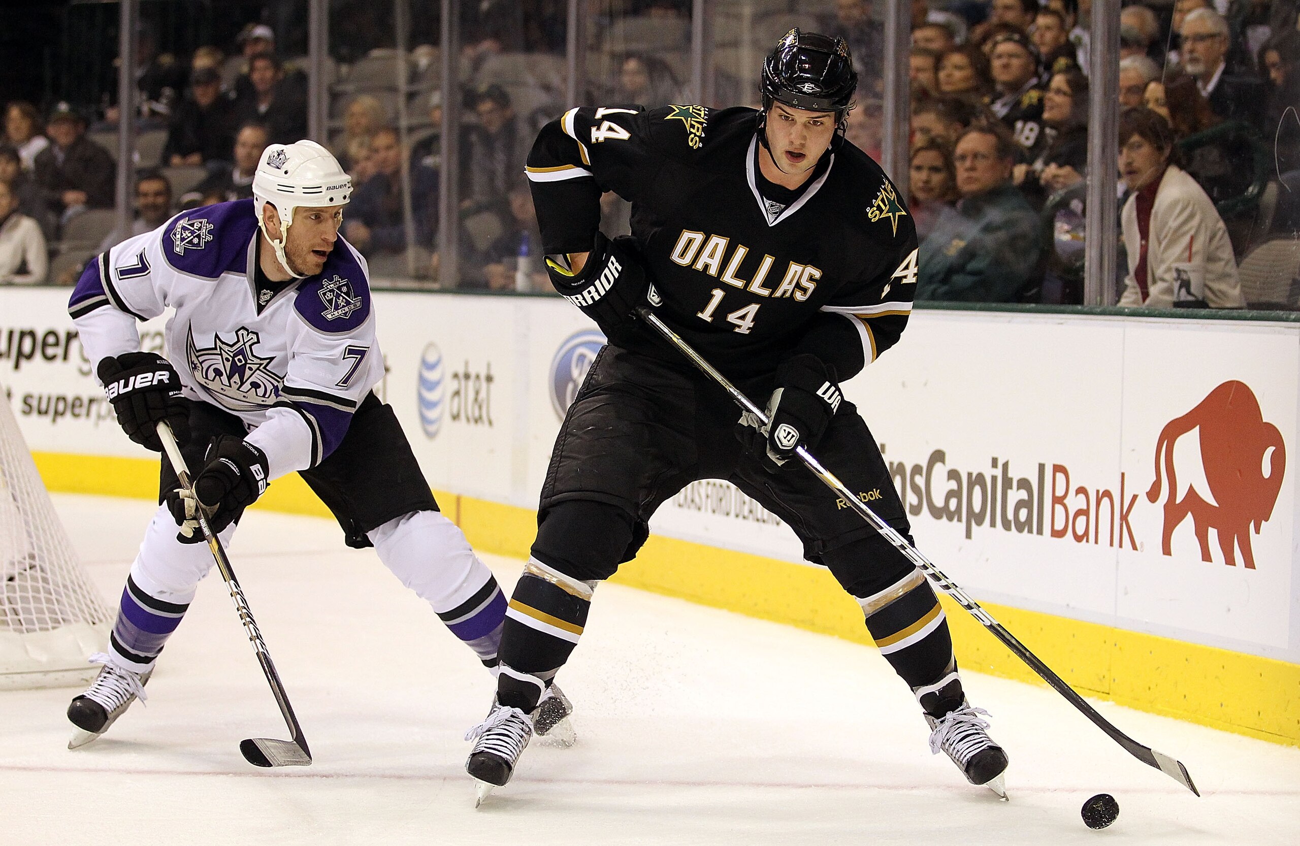 DALLAS, TX - JANUARY 17:  Left wing Jamie Benn #14 of the Dallas Stars skates the puck past Rob Scuderi #7 of the Los Angeles Kings at American Airlines Center on January 17, 2011 in Dallas, Texas.  (Photo by Ronald Martinez/Getty Images)