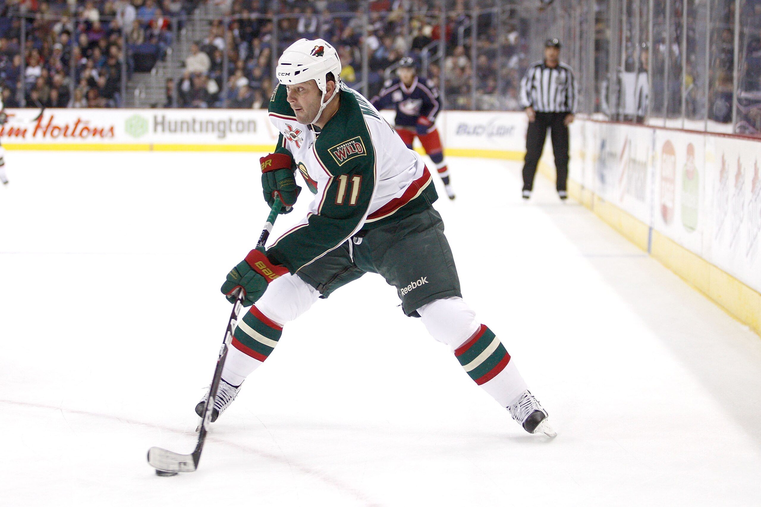 COLUMBUS,OH - NOVEMBER 06:  John Madden #11 of the Minnesota Wild skates with the puck against the Columbus Blue Jackets on November 6, 2010 at Nationwide Arena in Columbus, Ohio.  (Photo by John Grieshop/Getty Images)