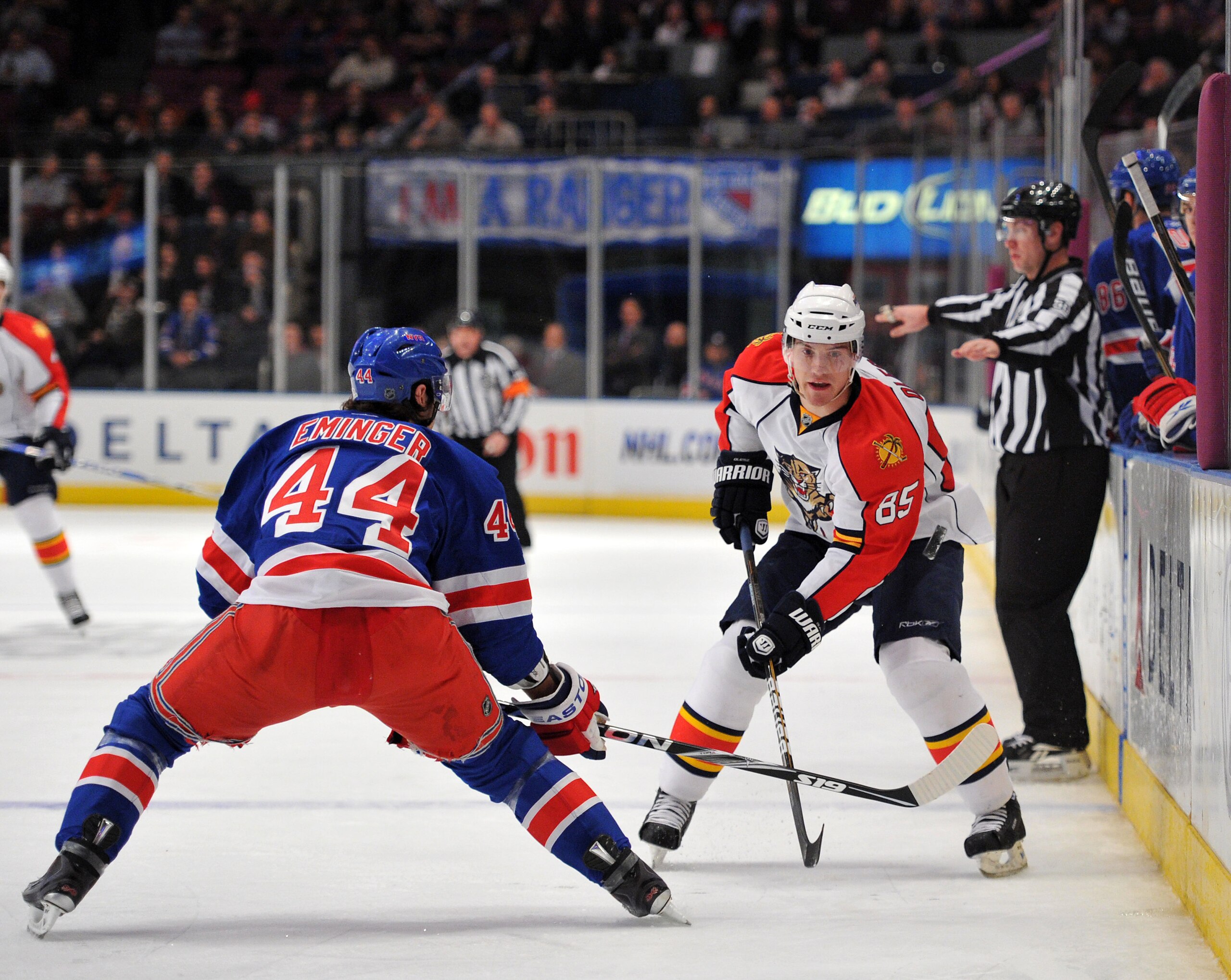 NEW YORK, NY - JANUARY 25: Steve Eminger #44 of the New York Rangers and Rostislav Olesz #85 of the Florida Panthers play for possession of the puck along the boards during the first period at Madison Square Garden on January 25, 2011 in New York City. (P