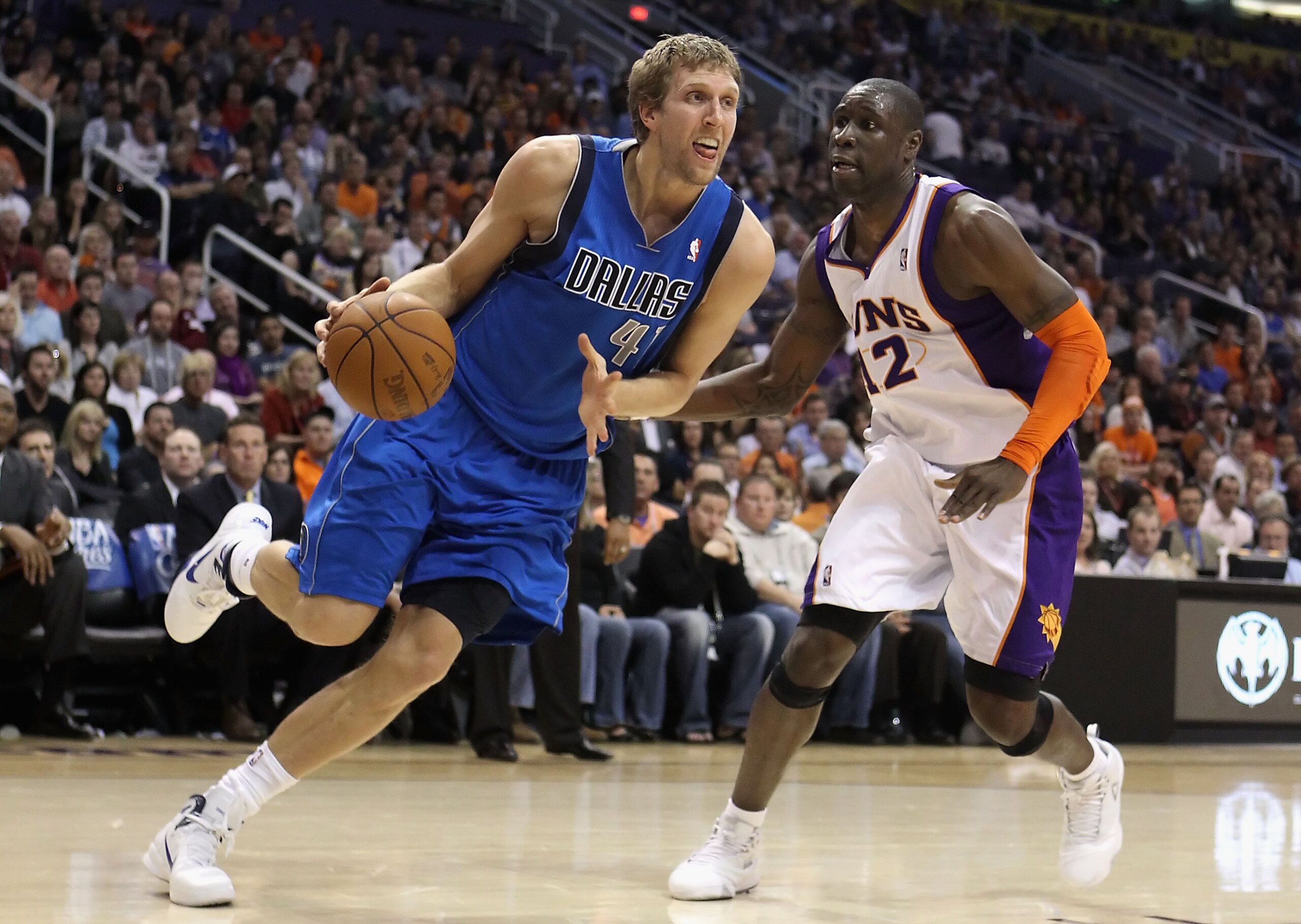PHOENIX, AZ - FEBRUARY 17:  Dirk Nowitzki #41 of the Dallas Mavericks drives the ball past Mickael Pietrus #12 of the Phoenix Suns during the NBA game at US Airways Center on February 17, 2011 in Phoenix, Arizona. The Mavericks defeated the Suns 112-106. 