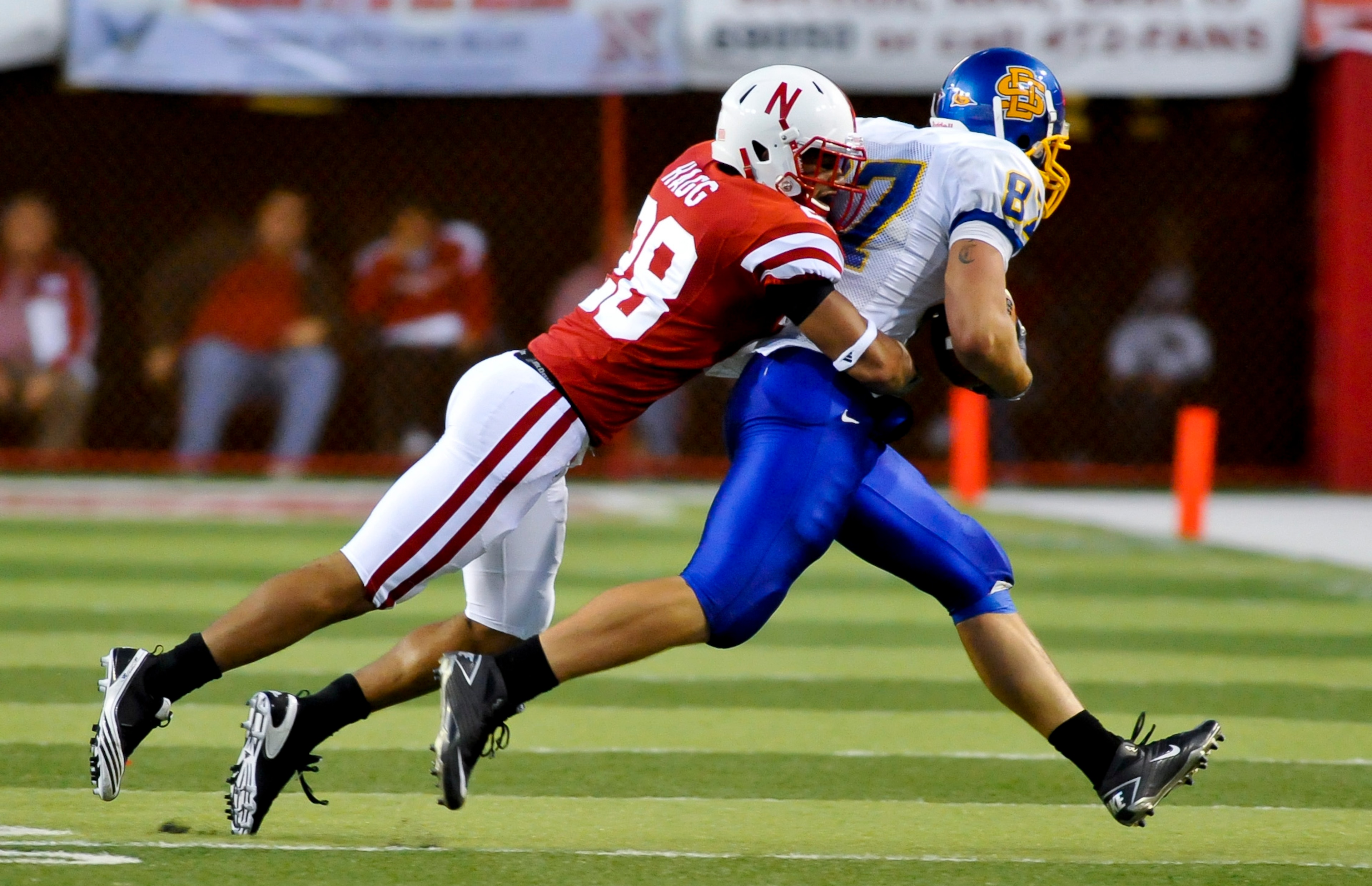 LINCOLN, NEBRASKA - SEPTEMBER 25: Nebraska Cornhuskers defensive back Eric Hagg #28 brings down South Dakota State Jackrabbits tight end Colin Cochart #87 during their game at Memorial Stadium on September 25, 2010 in Lincoln, Nebraska. Nebraska Defeated