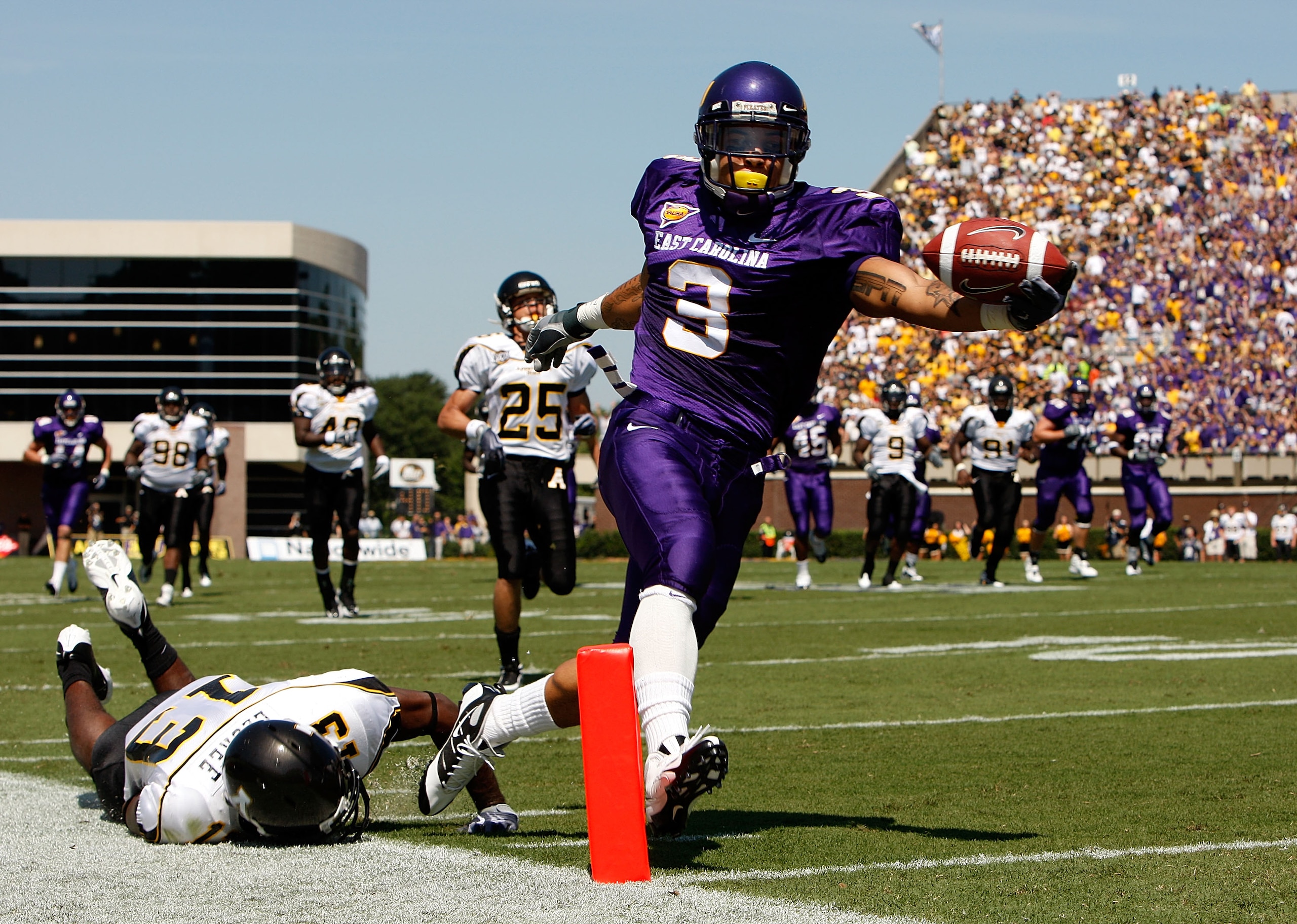GREENVILLE, NC - SEPTEMBER 05:  Mark LeGree #13 of the Appalachian State Mountaineers dives as Brandon Jackson #3 of the East Carolina Pirates scores a touchdown at Dowdy-Ficklen Stadium on September 5, 2009 in Greenville, North Carolina.  (Photo by Stree