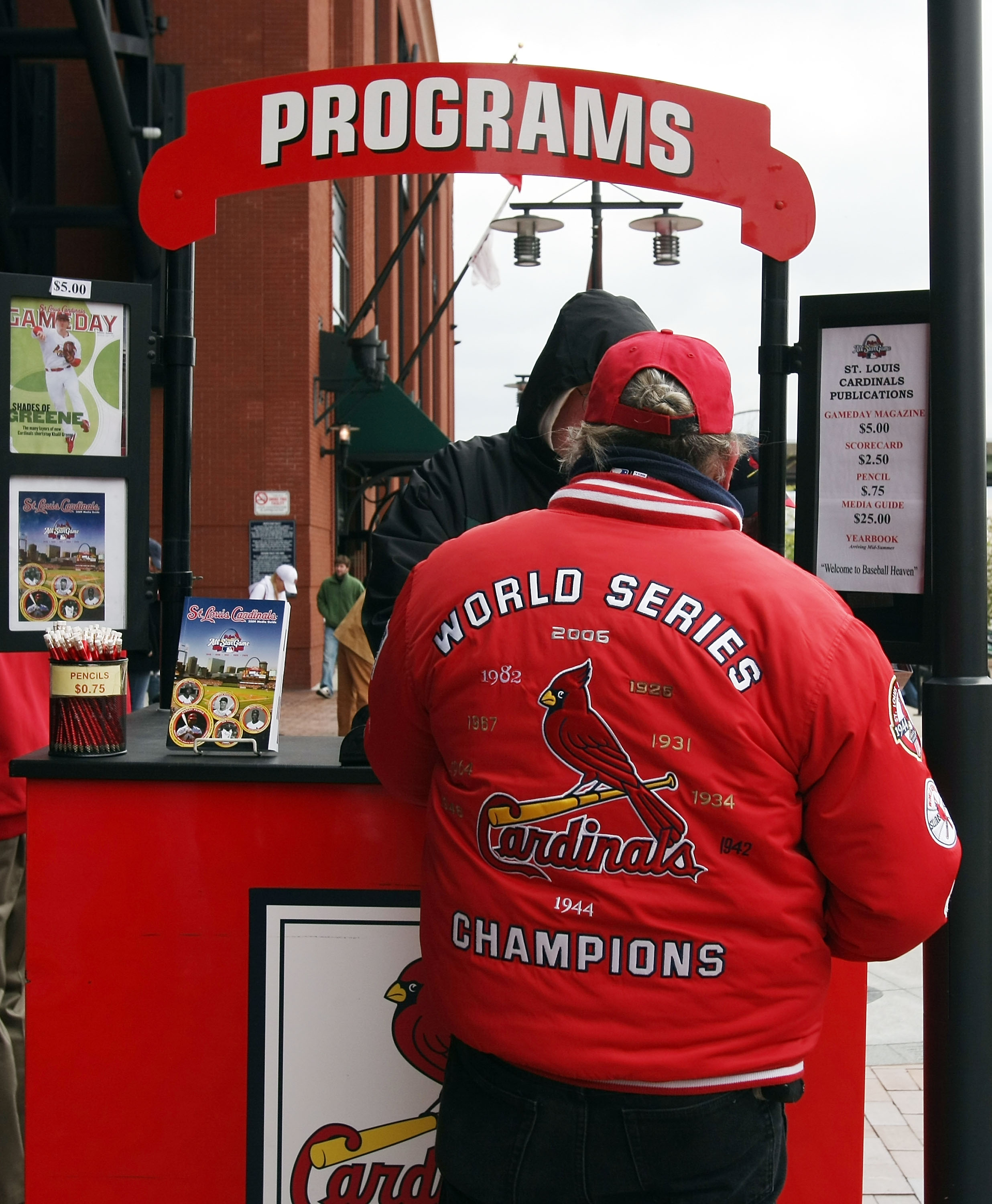 ST. LOUIS - APRIL 06:  Fans buy programs before the game between the St. Louis Cardinals and the Pittsburgh Pirates during Opening Day on April 6, 2009  at Busch Stadium in St. Louis, Missouri.  (Photo by Elsa/Getty Images)