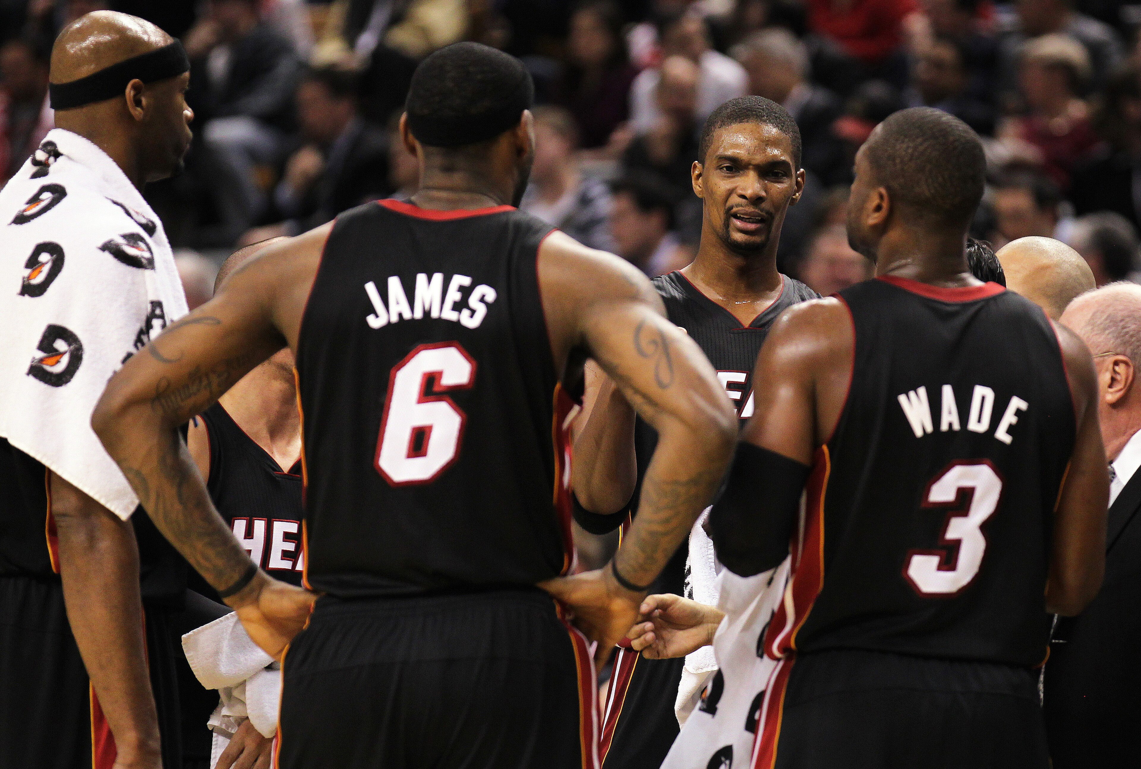 TORONTO, CANADA - FEBRUARY 16:  Chris Bosh #1 of the Miami Heat talks to teammates LeBron James #6 and Dwyane Wade #3 during a timeout in a game against the Toronto Raptors on February 16, 2011 at the Air Canada Centre in Toronto, Canada. The Heat defeate