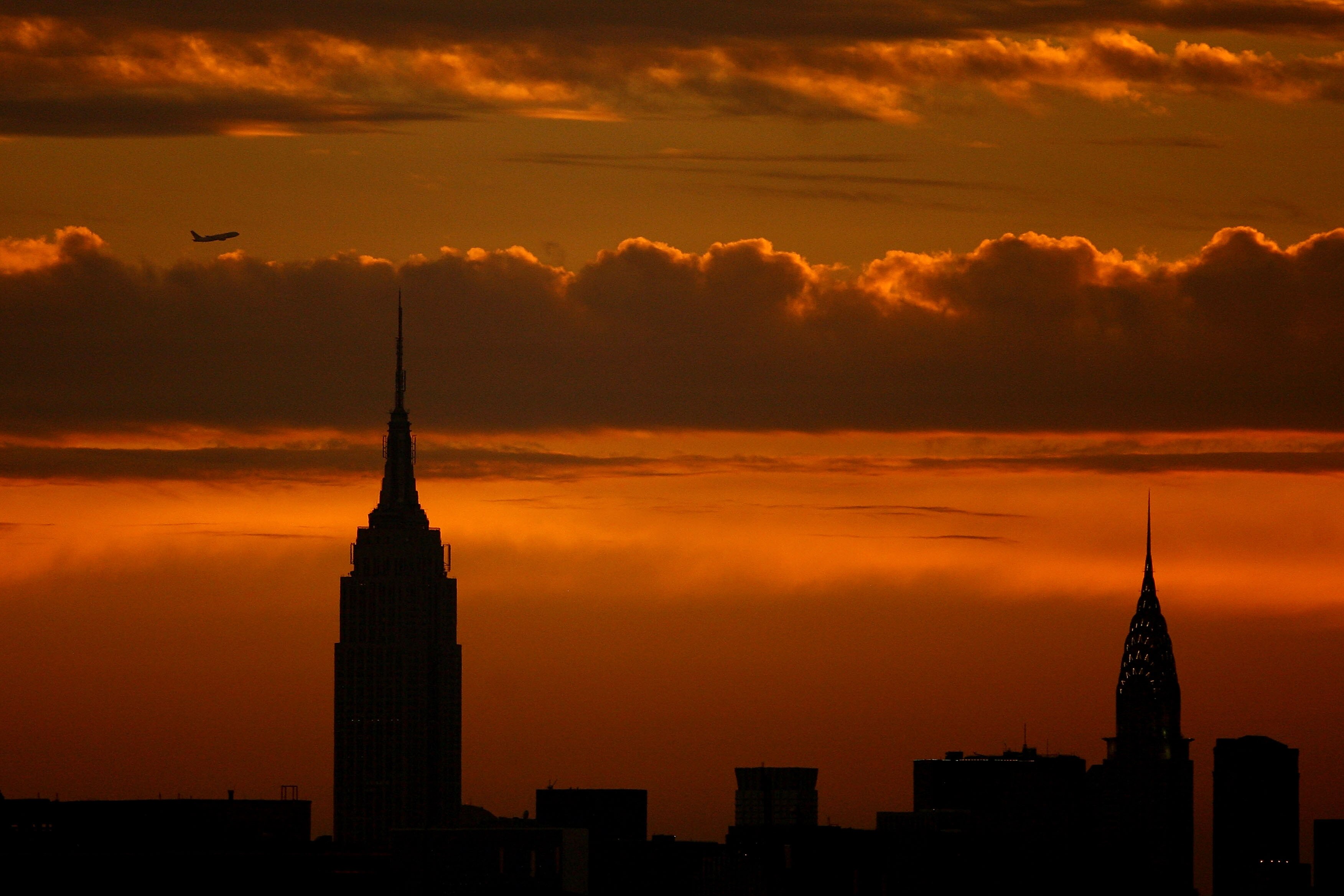 NEW YORK - SEPTEMBER 03:  The sun sets over the Empire State Building and the Chrystler Building during day five of the 2010 U.S. Open at the USTA Billie Jean King National Tennis Center on September 3, 2010 in the Flushing neighborhood of the Queens boro