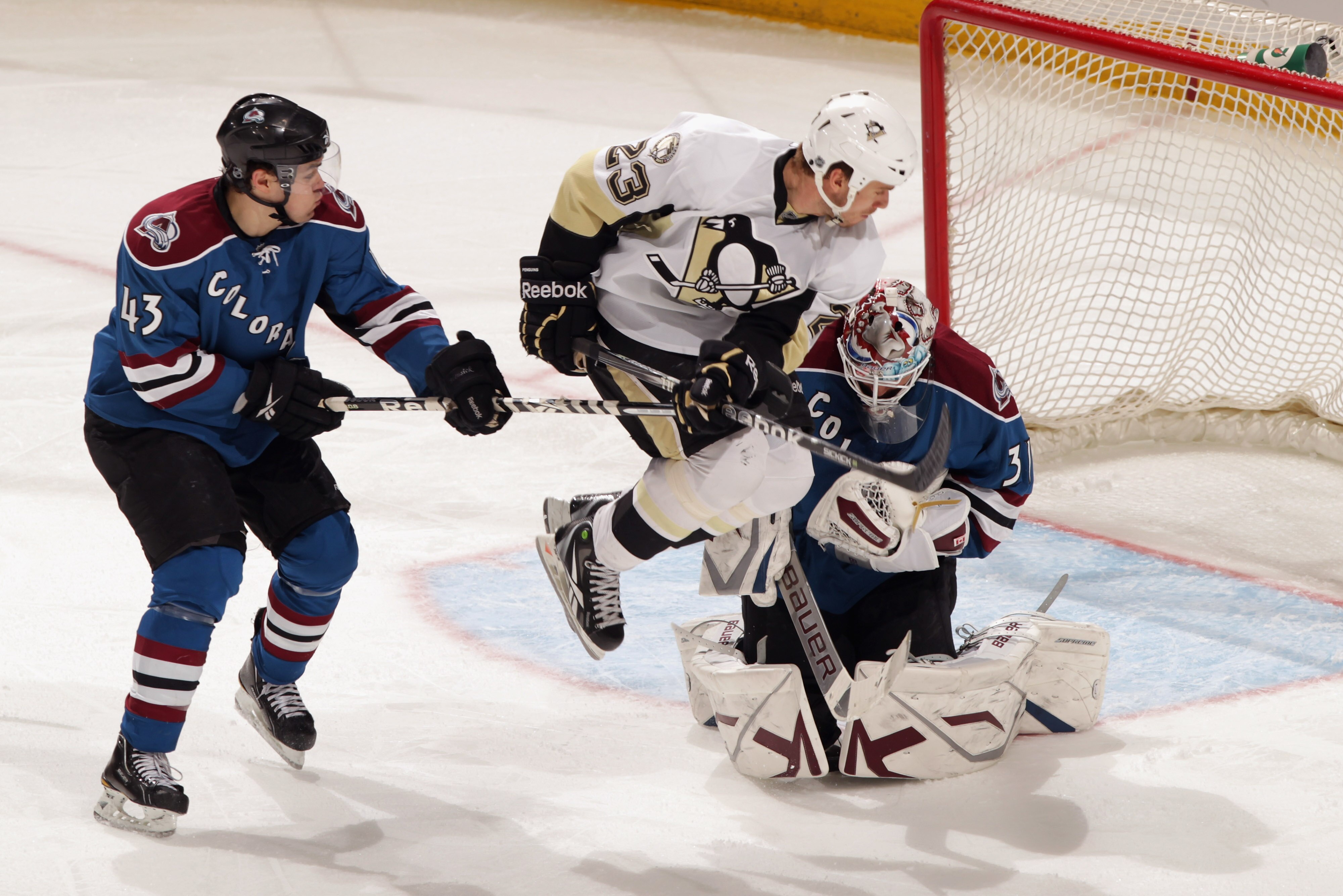 DENVER, CO - FEBRUARY 16:  Ryan Craig #23 of the Pittsburgh Penguins jumps to screen a shot as Cameron Gaunce #43 of the Colorado Avalanche as defends and goalie Peter Budaj #31 of the Avalanche collects the puck at the Pepsi Center on February 16, 2011 i
