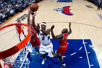 ATLANTA, GA - MAY 06:  Joe Johnson #2 of the Atlanta Hawks shoots over Joakim Noah #13 and Luol Deng #9 of the Chicago Bulls in Game Three of the Eastern Conference Semifinals in the 2011 NBA Playoffs at Phillips Arena on May 6, 2011 in Atlanta, Georgia.
