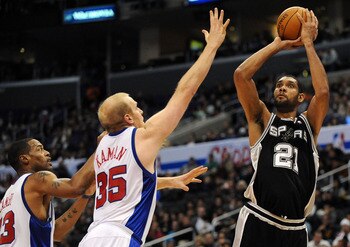 LOS ANGELES, CA - DECEMBER 13:  Tim Duncan #21 of the San Antonio Spurs shoots a jumper over Chris Kaman #35 and Marcus Camby #23 of the Los Angeles Clippers during the game at Staples Center on December 13, 2009 in Los Angeles, California.  NOTE TO USER: