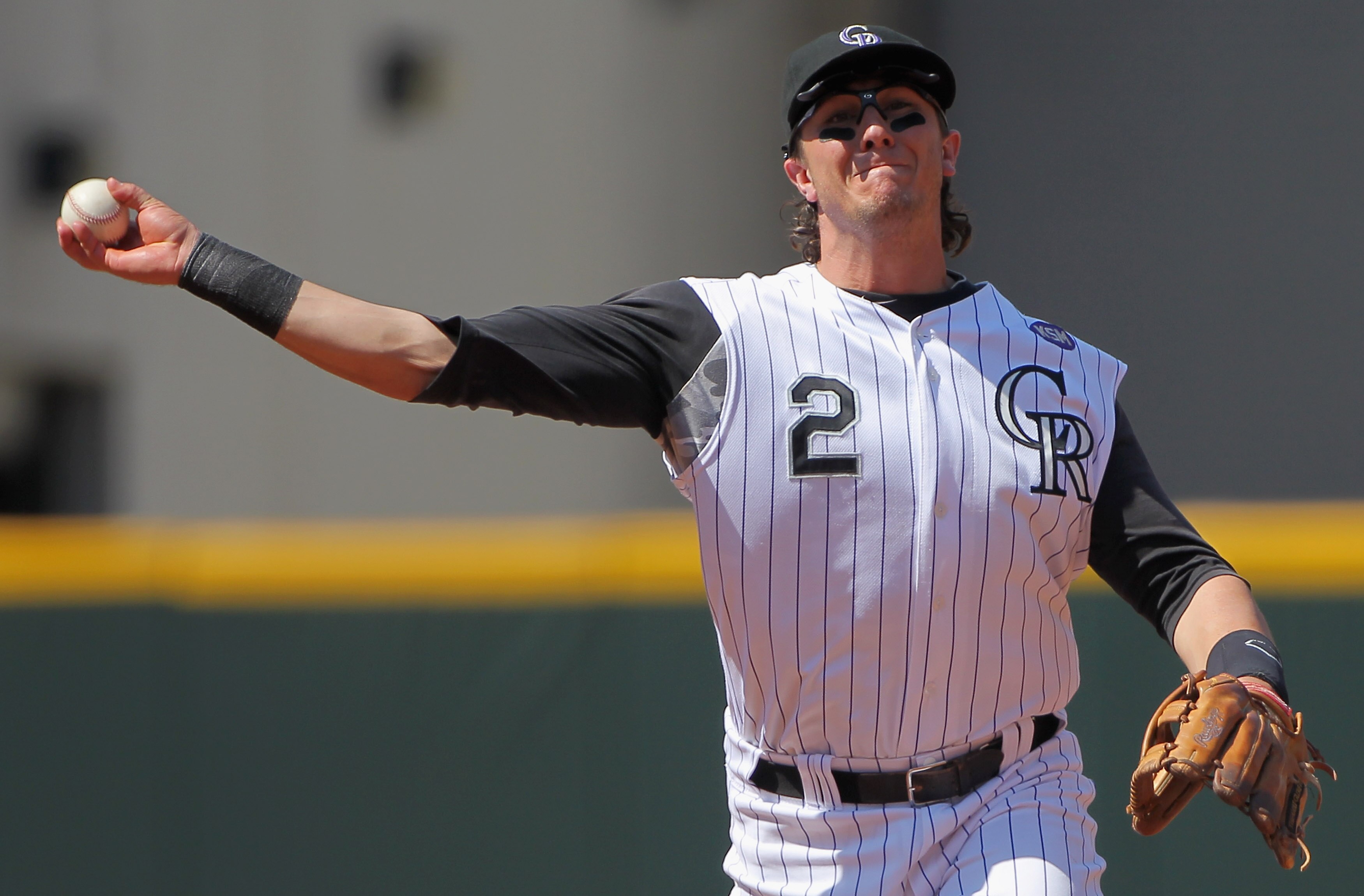 DENVER - SEPTEMBER 15:  Troy Tulowitzki #2 of the Colorado Rockies throws out a runner against the San Diego Padres at Coors Field on September 15, 2010 in Denver, Colorado. The Rockies defeated the Padres 9-6.  (Photo by Doug Pensinger/Getty Images)