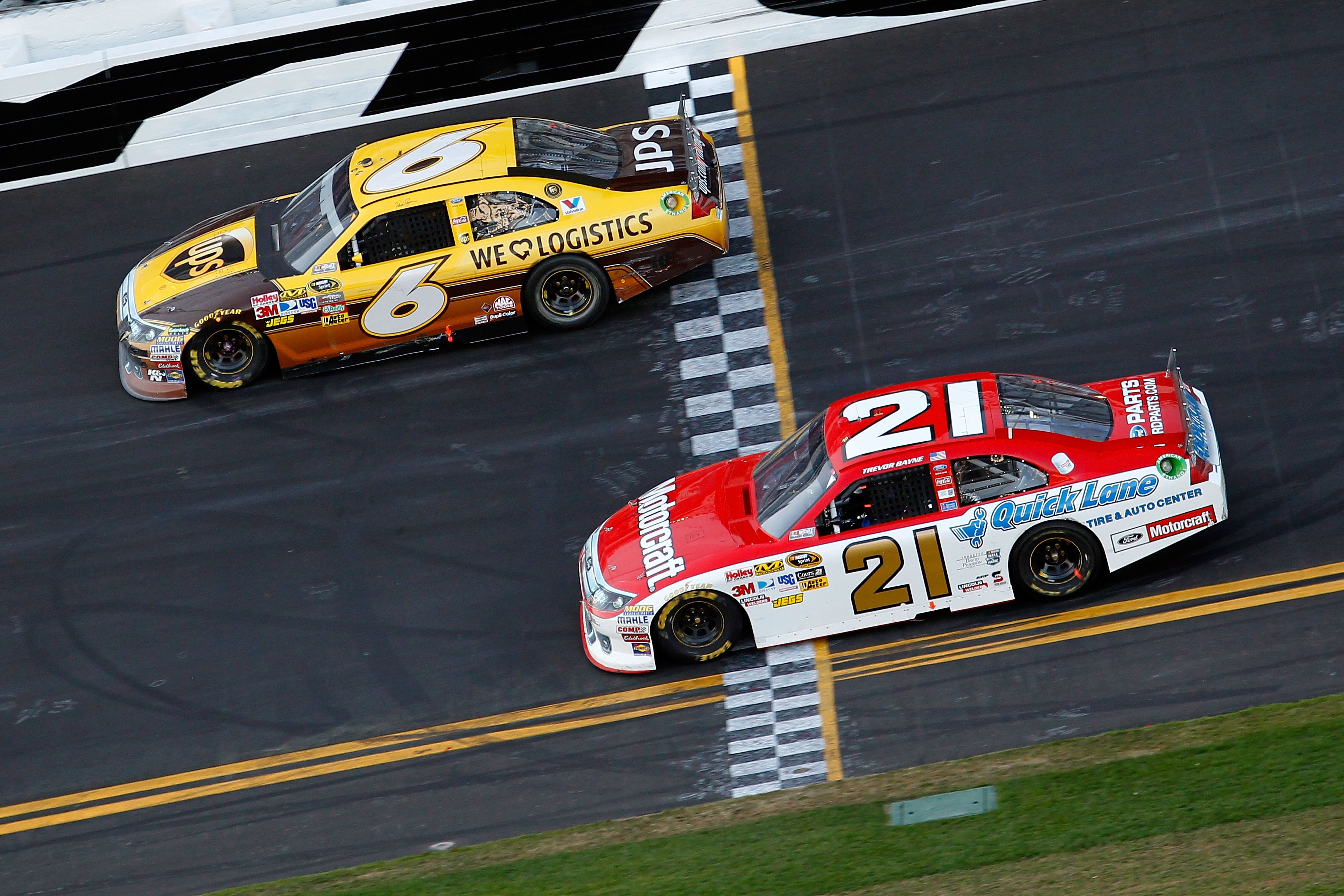 DAYTONA BEACH, FL - FEBRUARY 20:  David Ragan, driver of the #6 UPS Ford, and Trevor Bayne, driver of the #21 Motorcraft/Quick Lane Ford, race during the NASCAR Sprint Cup Series Daytona 500 at Daytona International Speedway on February 20, 2011 in Dayton