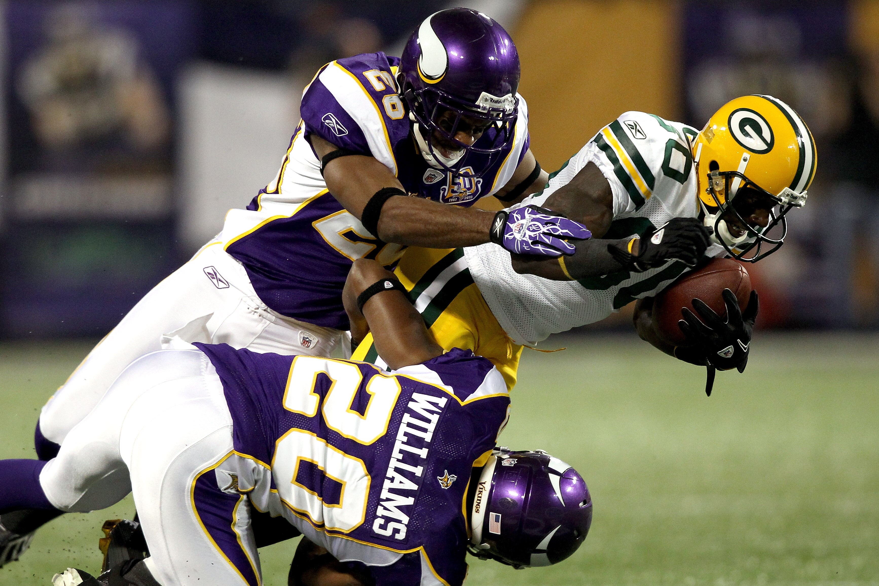 MINNEAPOLIS - NOVEMBER 21: Donald Driver #80 of the Green Bay Packers is brought down by Antonio Winfield #26 and Madieu Williams #20 of the Minnesota Vikings at the Hubert H. Humphrey Metrodome on November 21, 2010 in Minneapolis, Minnesota.  (Photo by M