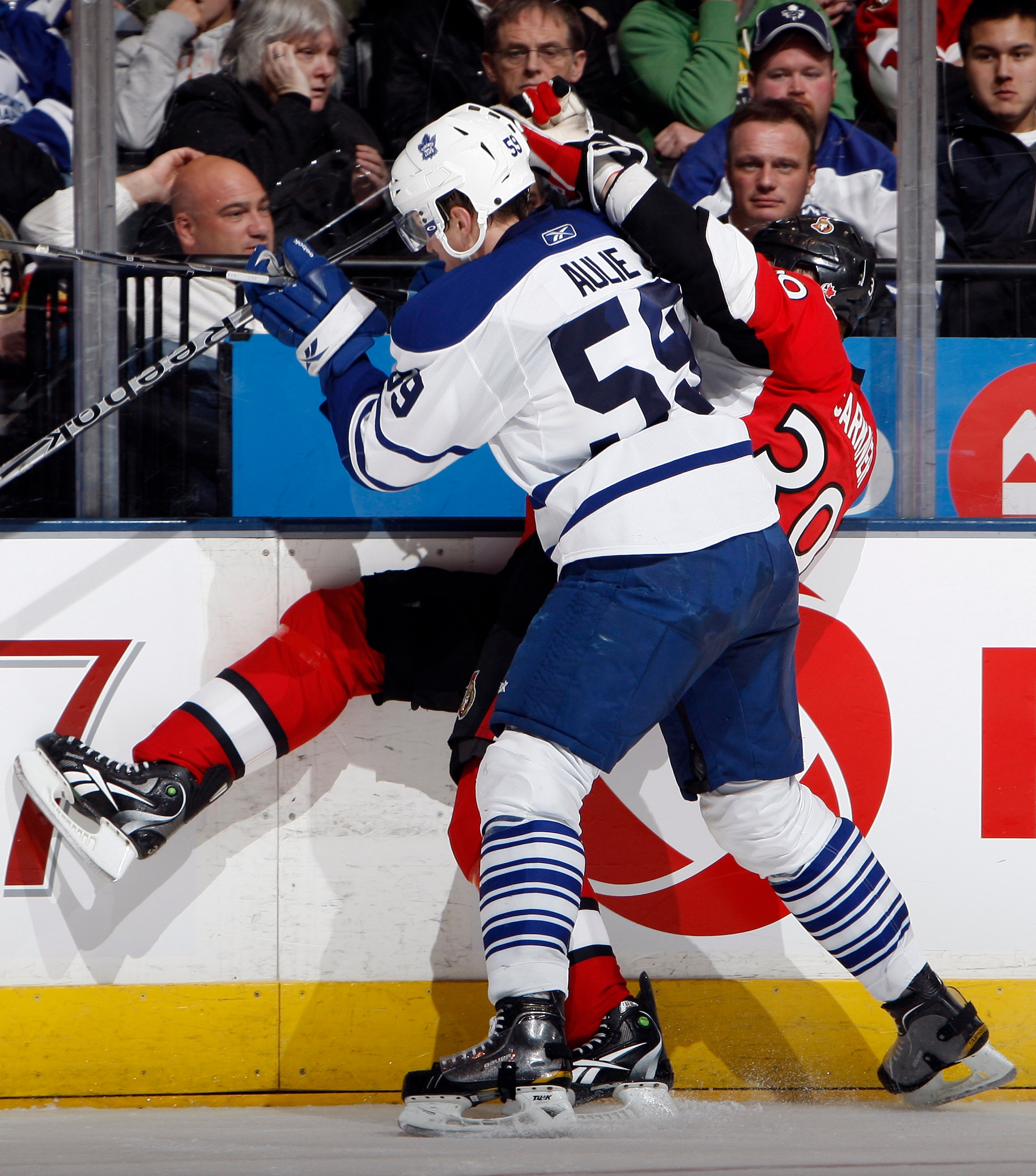 TORONTO, CANADA - FEBRUARY 19: Keith Aulie #59 of the Toronto Maple Leafs hits Matt Carkner #39 of the Ottawa Senators at the Air Canada Centre February 19, 2011 in Toronto, Ontario, Canada. (Photo by Abelimages/Getty Images)