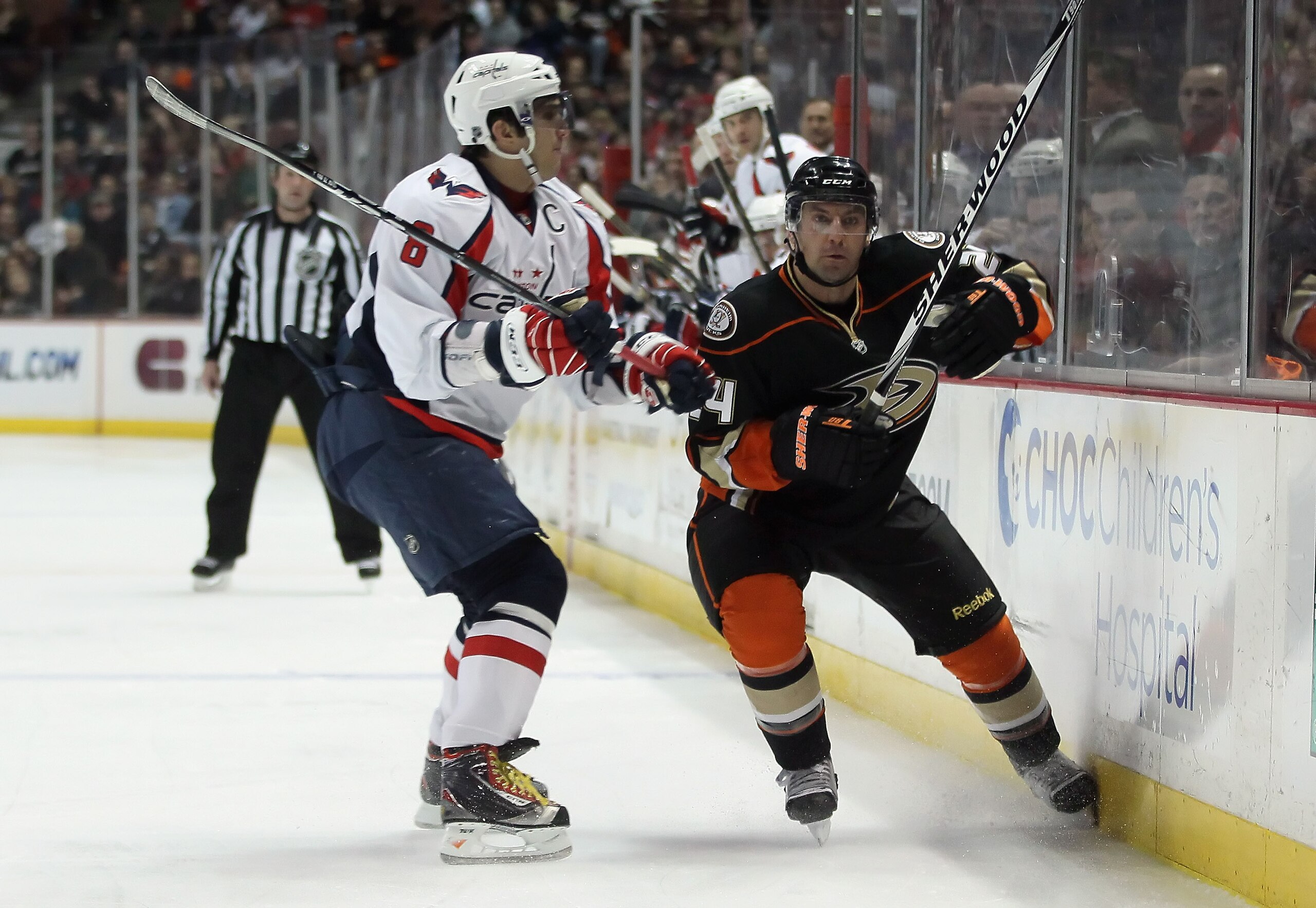ANAHEIM, CA - FEBRUARY 16:  Alex Ovechkin #8 of the Washington Capitals checks Francois Beauchemin #24 of the Anaheim Ducks into the boards in the first period at the Honda Center on February 16, 2011 in Anaheim, California. The Capitals defeated the Duck