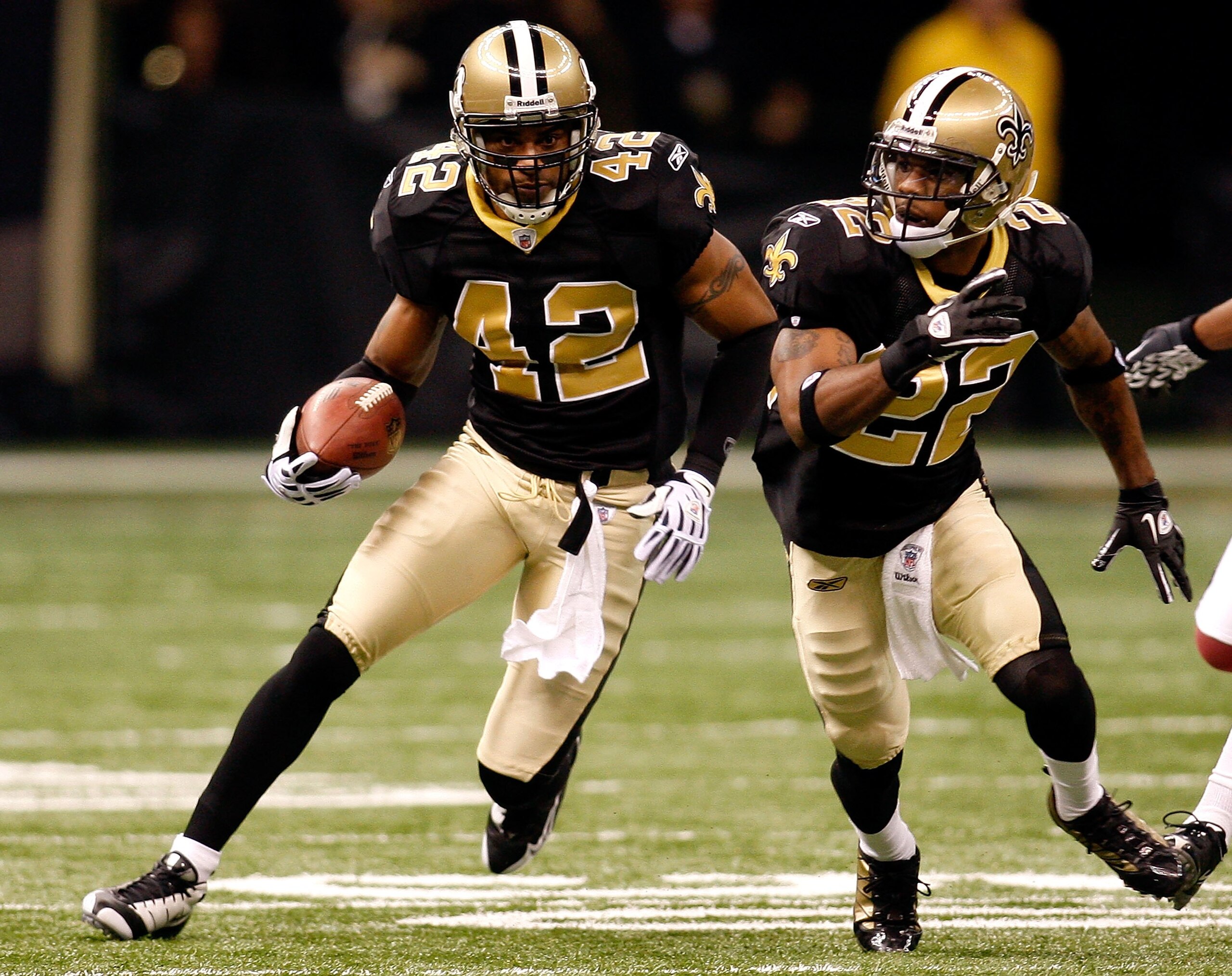 NEW ORLEANS - JANUARY 16: Darren Sharper #42 of the New Orleans Saints returns a fumble recovery for positive yards as Tracy Porter #22 looks to block against the Arizona Cardinals during the NFC Divisional Playoff Game at Louisana Superdome on January 1 NEW ORLEANS - JANUARY 16: Darren Sharper #42 of the New Orleans Saints returns a fumble recovery for positive yards as Tracy Porter #22 looks to block against the Arizona Cardinals during the NFC Divisional Playoff Game at Louisana Superdome on January 1
