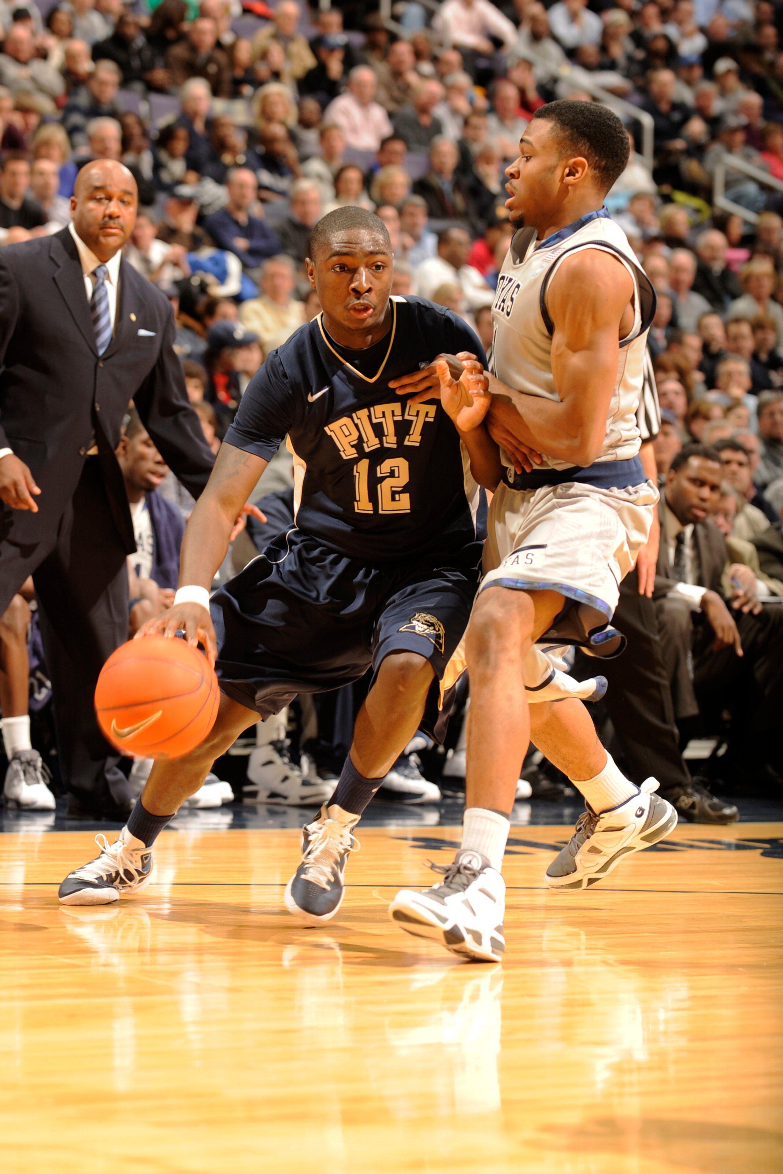 WASHINGTON, DC- JANUARY 12: Ashton Gibbs #12 of the Pittsburgh Panthers dribbles around Vee Sanford #11 of the Georgetown Hoyas during a college basketball game on January 12, 2011 at the Verizon Center in Washington, DC. The Panthers won 72-57. (Photo WASHINGTON, DC- JANUARY 12: Ashton Gibbs #12 of the Pittsburgh Panthers dribbles around Vee Sanford #11 of the Georgetown Hoyas during a college basketball game on January 12, 2011 at the Verizon Center in Washington, DC. The Panthers won 72-57. (Photo