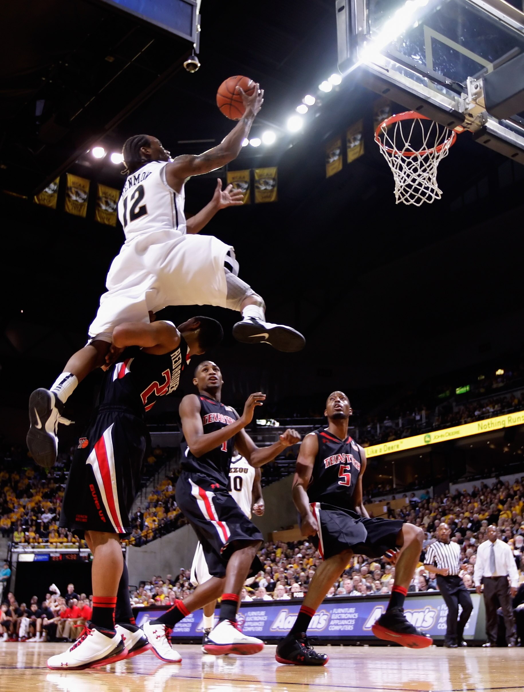 COLUMBIA, MO - FEBRUARY 15:  Marcus Denmon #12 of the Missouri Tigers leaps over Texas Tech Red Raiders defenders on his way toward scoring during the game on February 15, 2011 at Mizzou Arena in Columbia, Missouri.  (Photo by Jamie Squire/Getty Images)