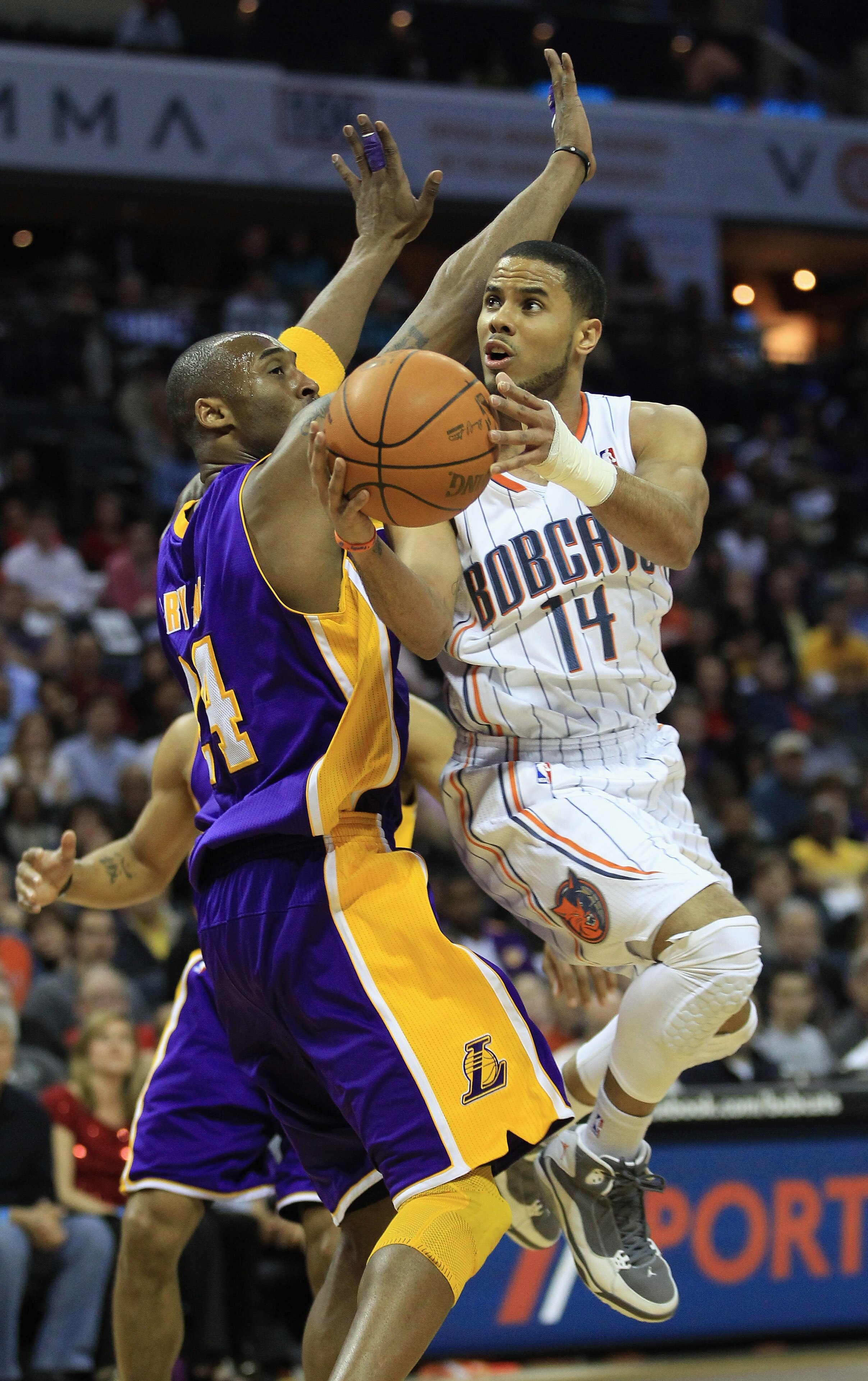 CHARLOTTE, NC - FEBRUARY 14:  Kobe Bryant #24 of the Los Angeles Lakers tries to stop D.J. Augustin #14 of the Charlotte Bobcats during their game at Time Warner Cable Arena on February 14, 2011 in Charlotte, North Carolina. NOTE TO USER: User expressly a
