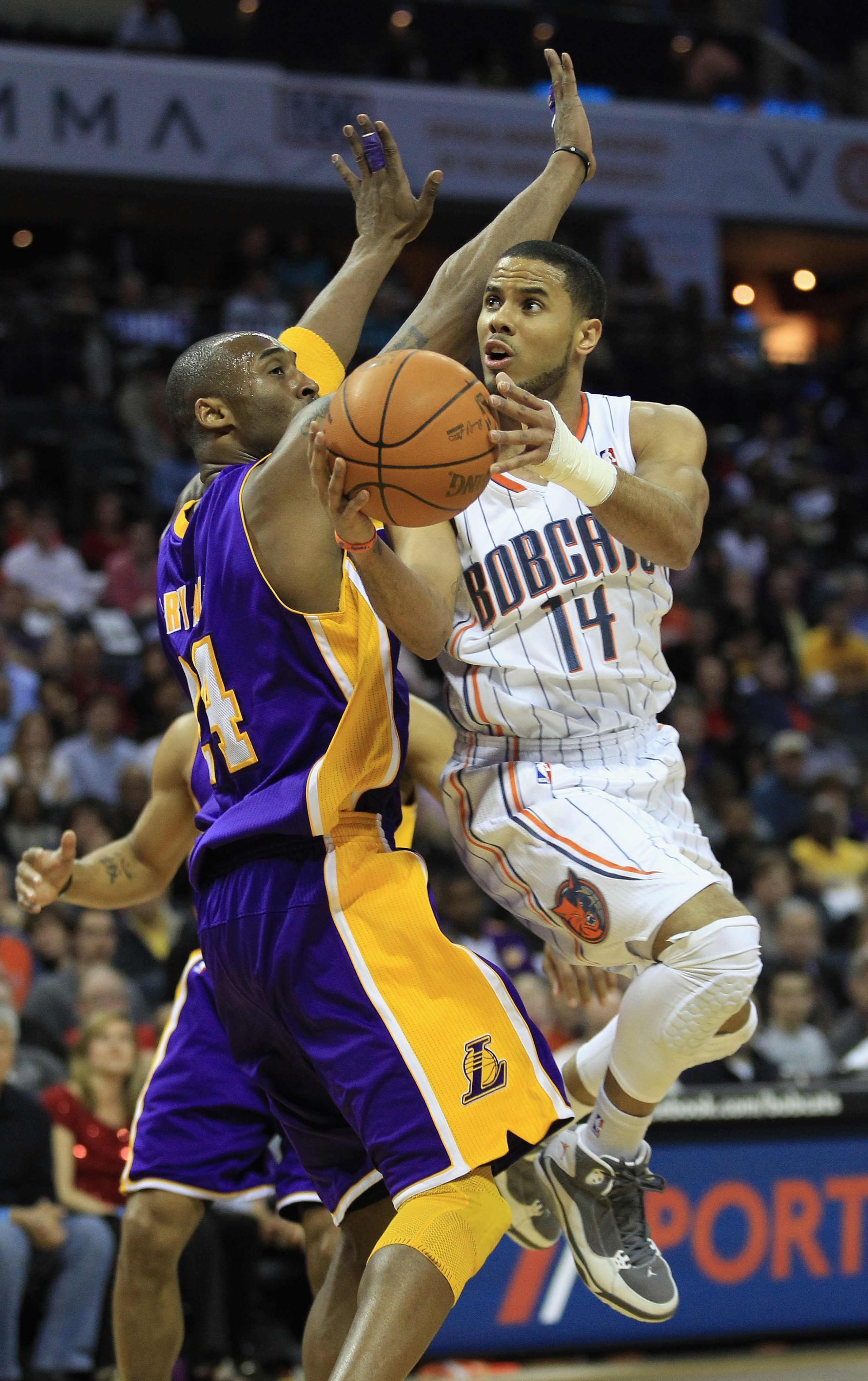 CHARLOTTE, NC - FEBRUARY 14:  Kobe Bryant #24 of the Los Angeles Lakers tries to stop D.J. Augustin #14 of the Charlotte Bobcats during their game at Time Warner Cable Arena on February 14, 2011 in Charlotte, North Carolina. NOTE TO USER: User expressly a