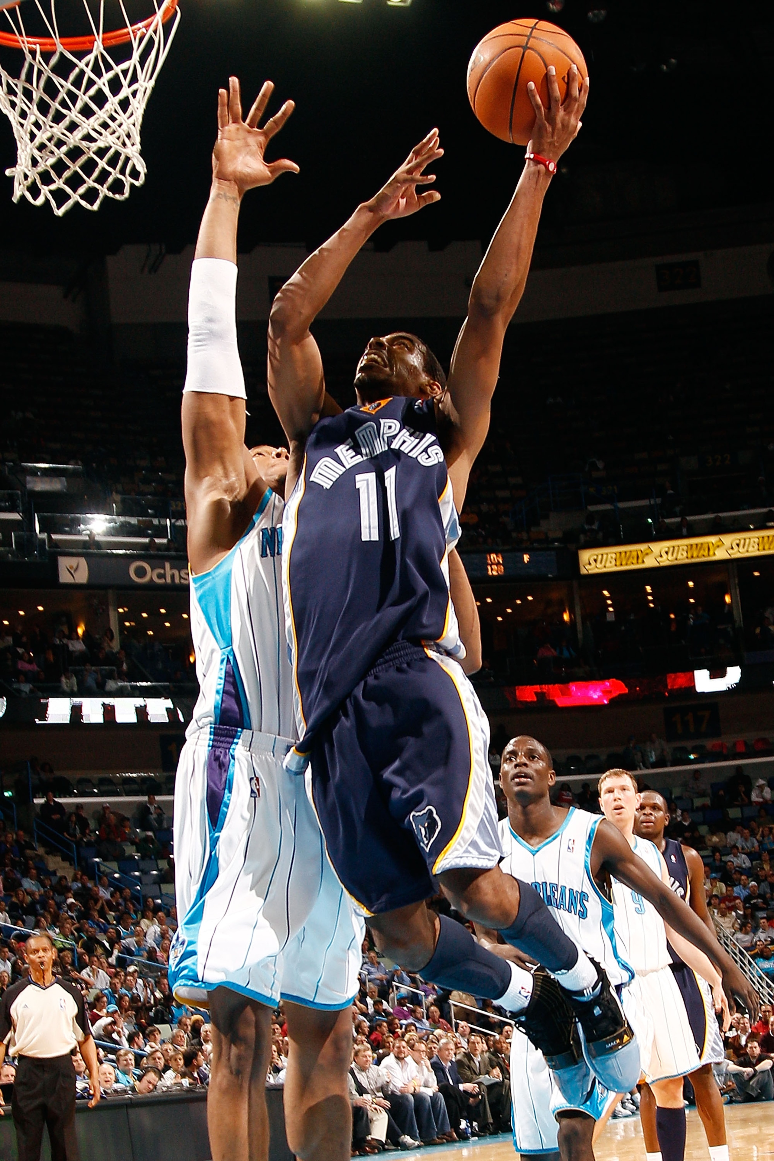 NEW ORLEANS - MARCH 03:  Mike Conley #11 of the Memphis Grizzlies shoots the ball over Daivd West #30 of the New Orleans Hornets at the New Orleans Arena on March 3, 2010 in New Orleans, Louisiana.  The Grizzlies defeated the Hornets 104-100.  NOTE TO USE