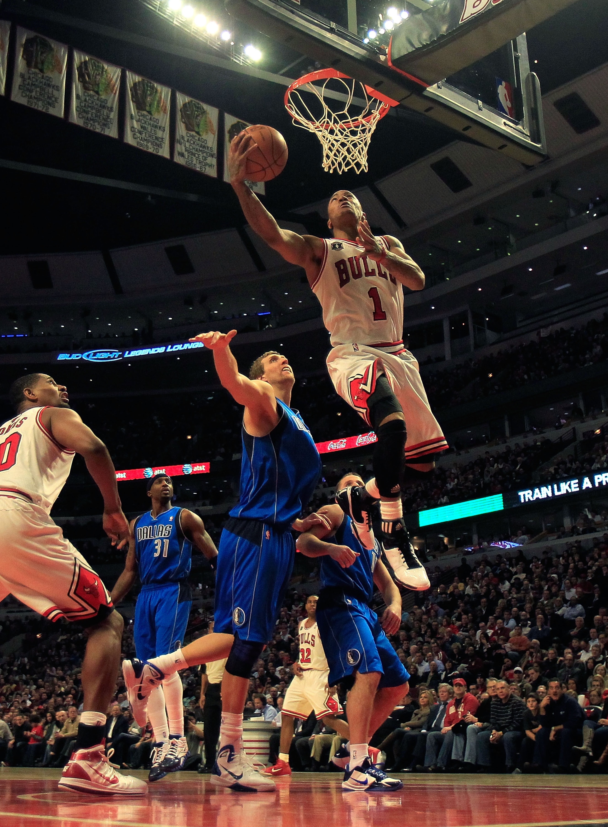 CHICAGO, IL - JANUARY 20: Derrick Rose #1 of the Chicago Bulls goes up for a shot over Dirk Nowitzki #41 of the Dallas Mavericks at the United Center on January 20, 2011 in Chicago, Illinois. The Bulls defeated the Mavericks 82-77. NOTE TO USER: User expr