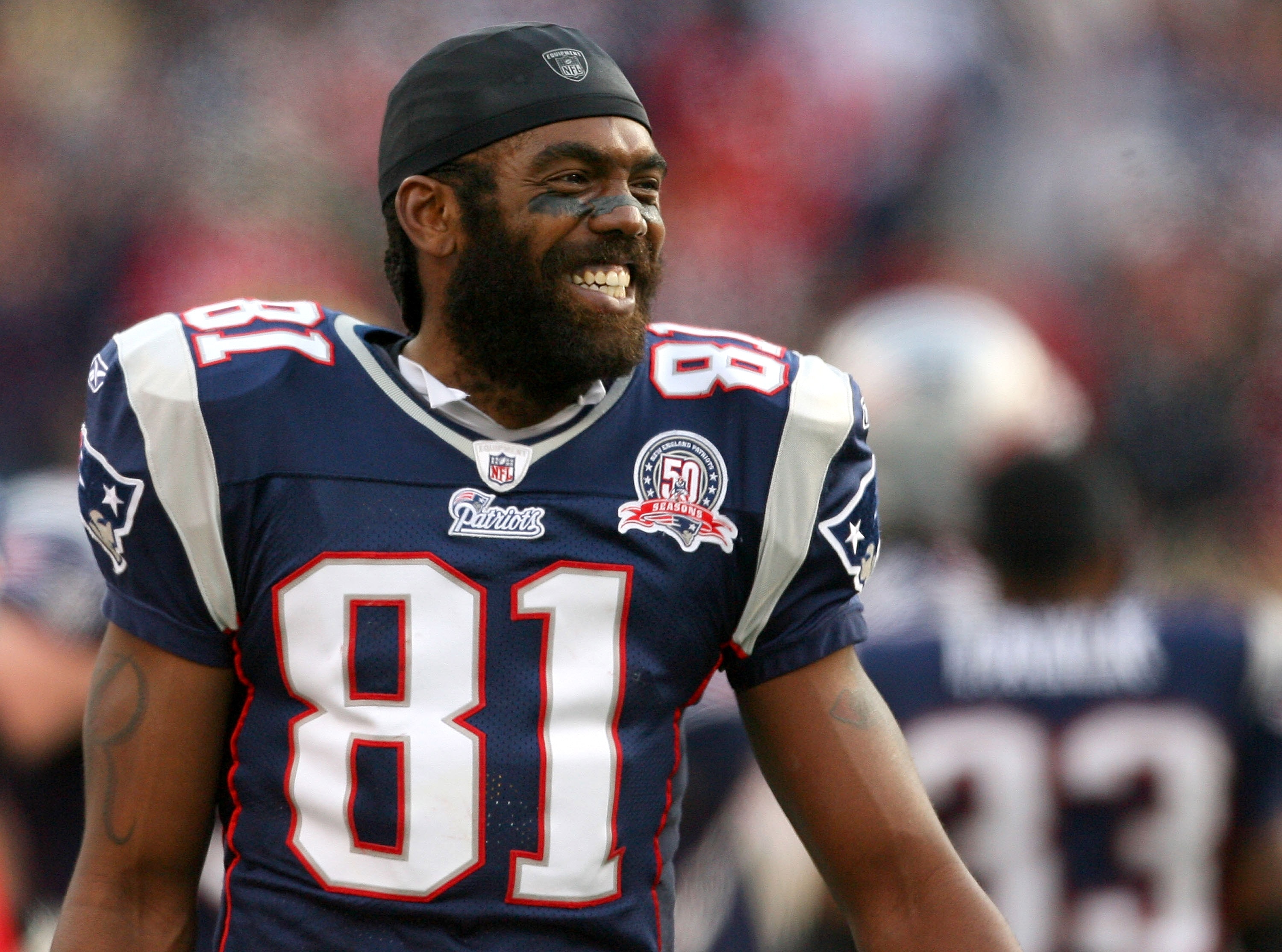 FOXBORO, MA - DECEMBER 27: Randy Moss #81 of the New England Patriots reacts on the sideline after he caught his third touchdown pass of the day against the Jacksonville Jaguars in the fourth quarter at Gillette Stadium on December 27, 2009 in Foxboro, Ma