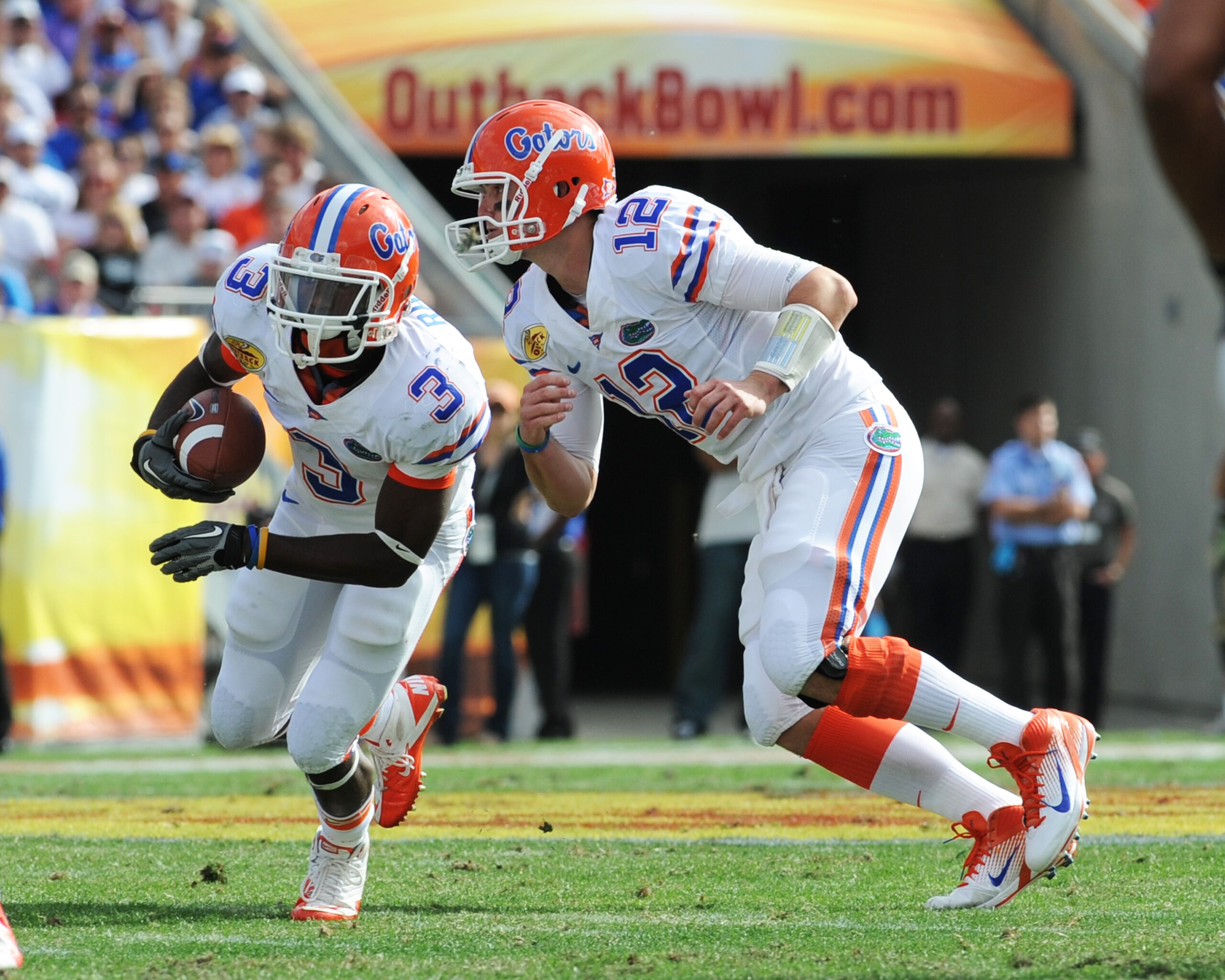 TAMPA, FL - JANUARY 1:  Quarterback John Brantley #12 of the Florida Gators hands off to running back Chris Rainey #3 against the Penn State Nittany Lions January 1, 2011 in the 25th Outback Bowl at Raymond James Stadium in Tampa, Florida.  (Photo by Al M