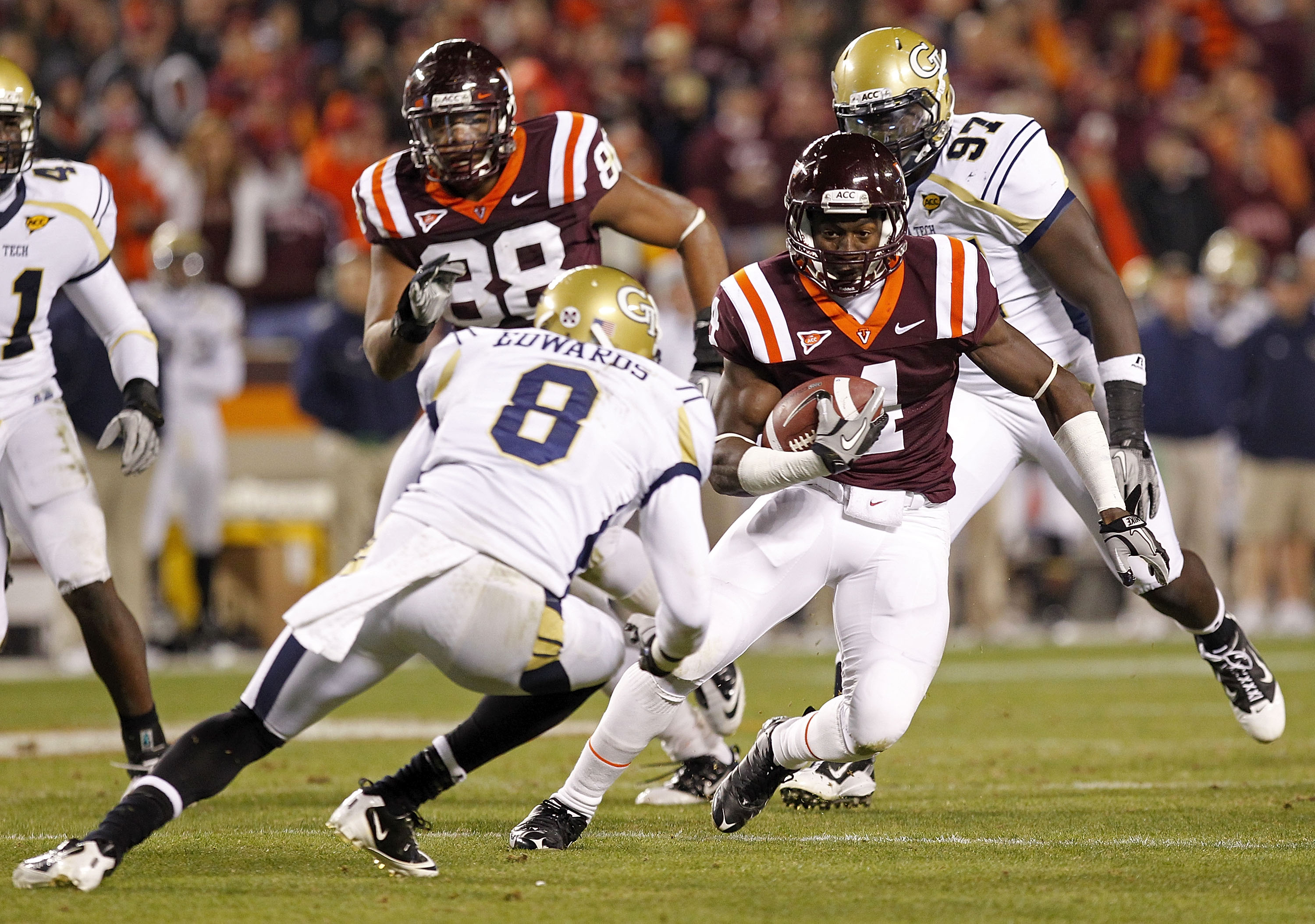 BLACKSBURG, VA - NOVEMBER 04: Running back David Wilson #4 of the Virginia Tech Hokies runs with the ball past cornerback Mario Edwards #8 of the Georgia Tech Yellow Jackets at Lane Stadium on November 4, 2010 in Blacksburg, Virginia.  (Photo by Geoff Bur