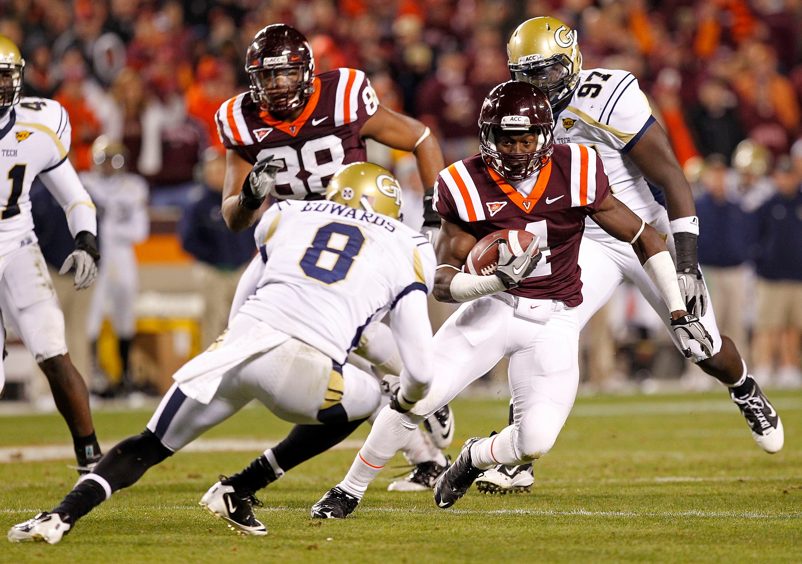 BLACKSBURG, VA - NOVEMBER 04: Running back David Wilson #4 of the Virginia Tech Hokies runs with the ball past cornerback Mario Edwards #8 of the Georgia Tech Yellow Jackets at Lane Stadium on November 4, 2010 in Blacksburg, Virginia.  (Photo by Geoff Bur