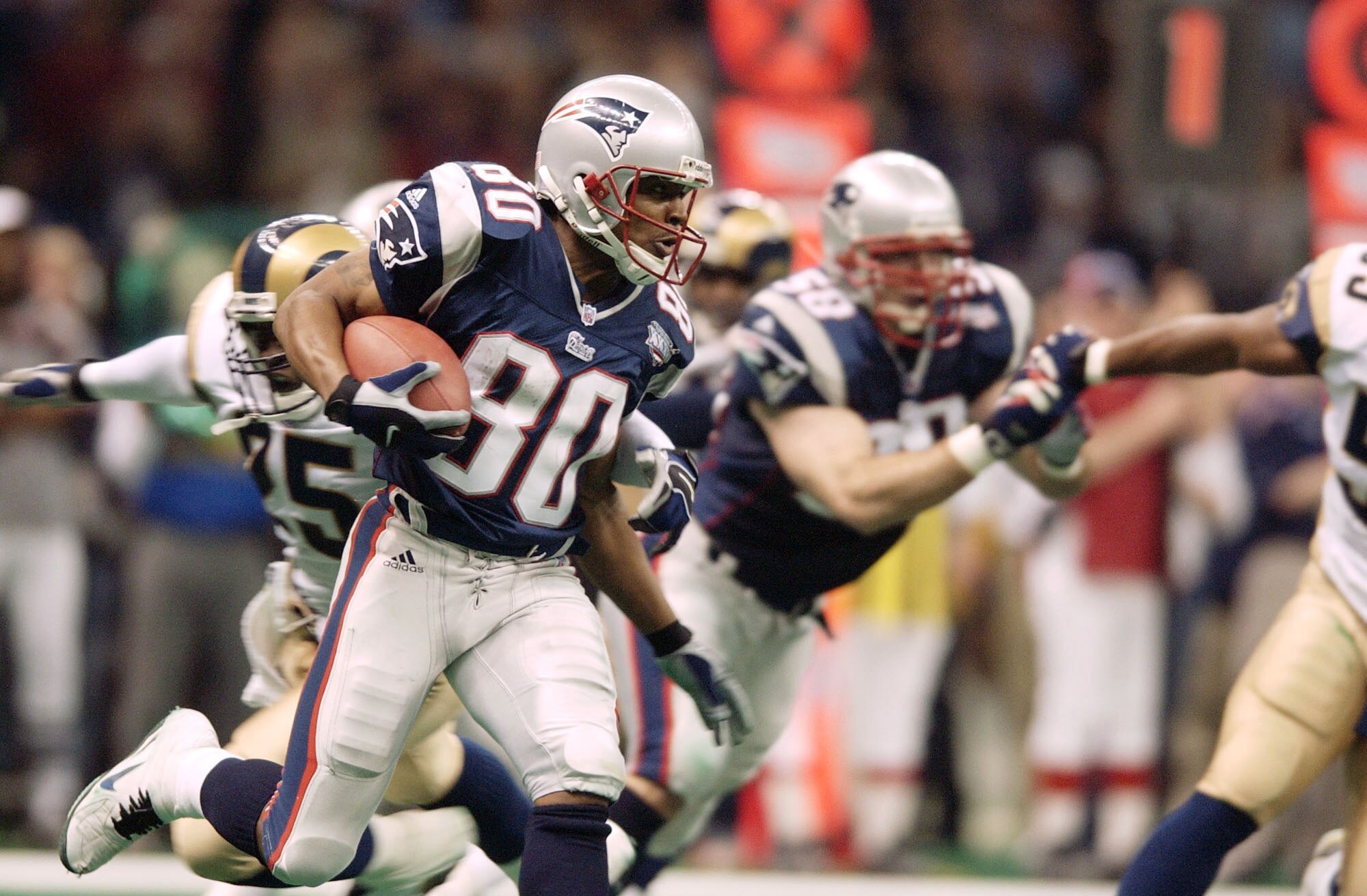 03 Feb 2002:   Troy Brown of the New England Patriots cradles the ball as he heads downfield against the St.Louis Rams during Superbowl XXXVI at the Superdome in New Orleans, Louisiana.  The Patriots won 20-17, with a 48-yard field goal by kicker Adam Vin