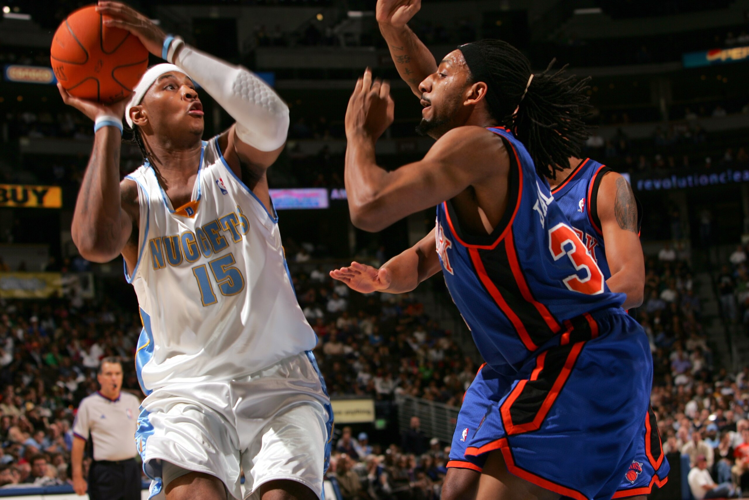 DENVER - NOVEMBER 8:  Carmelo Anthony #15 of the Denver Nuggets is defended by Renaldo Balkman #32 of the New York Knicks during the game on November 8, 2006 at the Pepsi Center in Denver, Colorado. The Knicks won 109-107. NOTE TO USER: User expressly ack