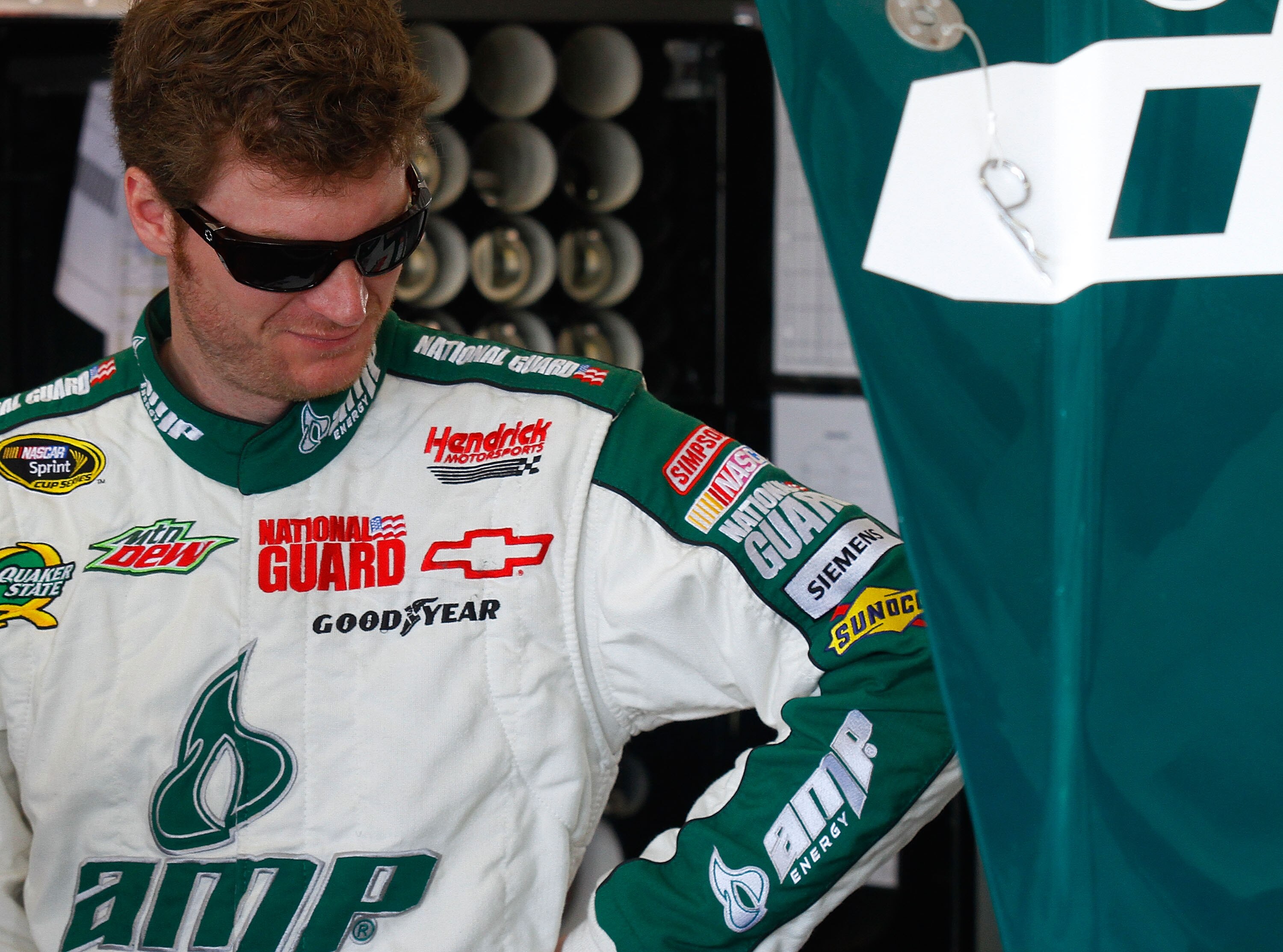 DAYTONA BEACH, FL - FEBRUARY 19:  Dale Earnhardt Jr., driver of the #88 National Guard/AMP Energy Chevrolet, looks on in the garage area during practice for the NASCAR Sprint Cup Series Daytona 500 at Daytona International Speedway on February 19, 2011 in