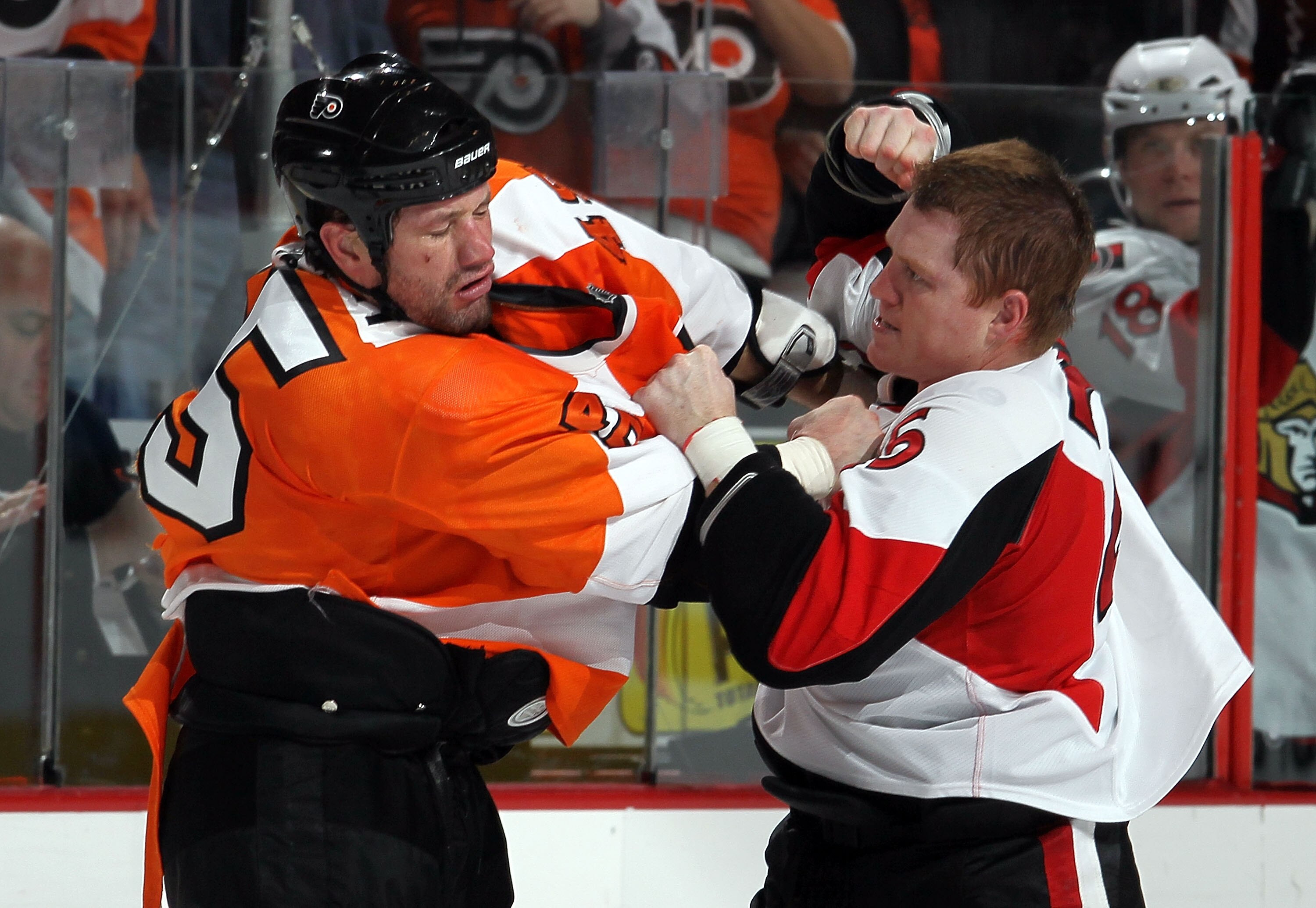 PHILADELPHIA, PA - JANUARY 20:  Chris Neil #25 of the Ottawa Senators trades punches with Jody Shelley #45 of the Philadelphia Flyers during the third period on January 20, 2011 at Wells Fargo Center in Philadelphia, Pennsylvania. The Flyers defeated the
