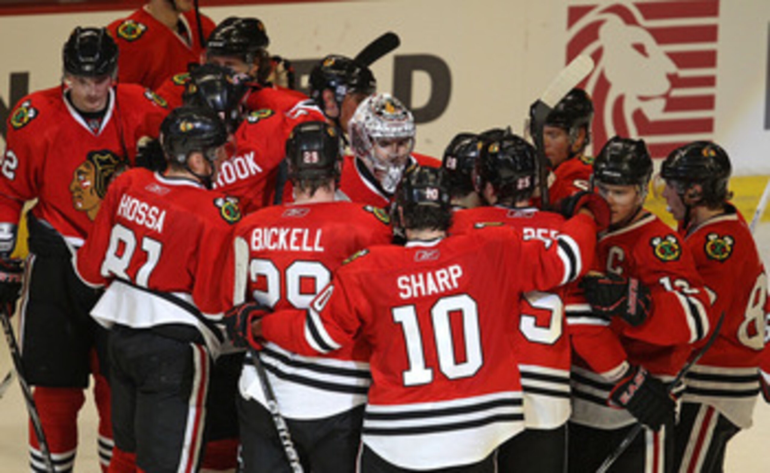 CHICAGO, IL - FEBRUARY 27: Corey Crawford #50 of the Chicago Blackhawks (center with mask) is surrounded by teammates including Marian Hossa #81, Bryan Bickell #29 and Patrick Sharp #10 after a win over the Phoenix Coyotes at the United Center on February