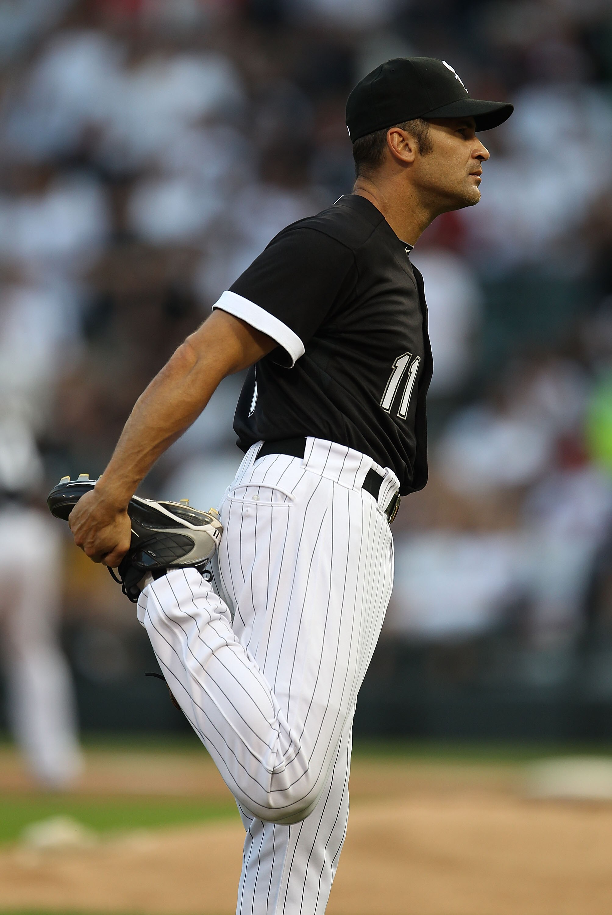 CHICAGO - AUGUST 10: Omar Vizquel #11 of the Chicago White Sox stretches before the start of a game against the Minnesota Twins at U.S. Cellular Field on August 10, 2010 in Chicago, Illinois. The Twins defeated the White Sox 12-6. (Photo by Jonathan Danie