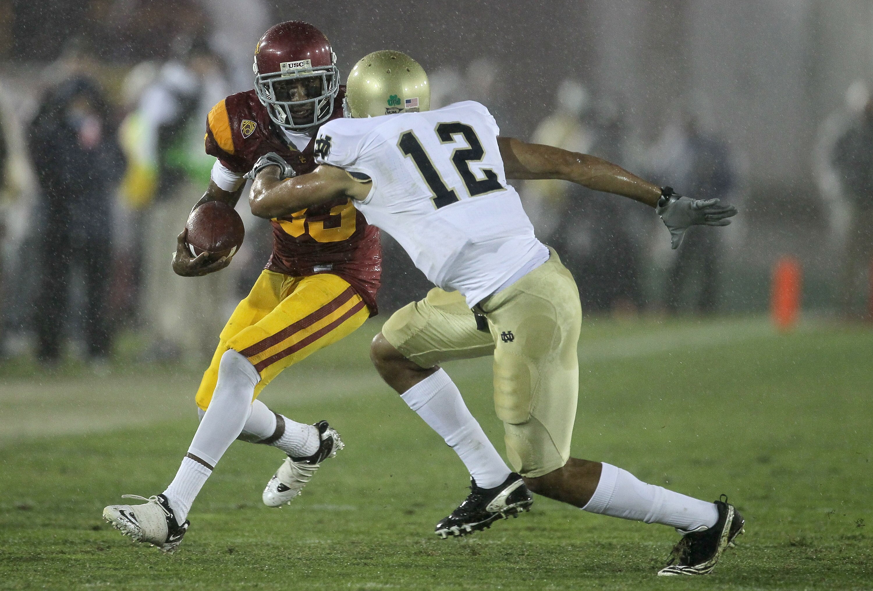 LOS ANGELES, CA - NOVEMBER 27: Wide receiver Ronald Johsnon #83 of the USC Trojans carries the ball against cornerback Robert Blanton #12 of the Notre Dame Fighting Irish at the Los Angeles Memorial Coliseum on November 27, 2010 in Los Angeles, Californi LOS ANGELES, CA - NOVEMBER 27: Wide receiver Ronald Johsnon #83 of the USC Trojans carries the ball against cornerback Robert Blanton #12 of the Notre Dame Fighting Irish at the Los Angeles Memorial Coliseum on November 27, 2010 in Los Angeles, Californi