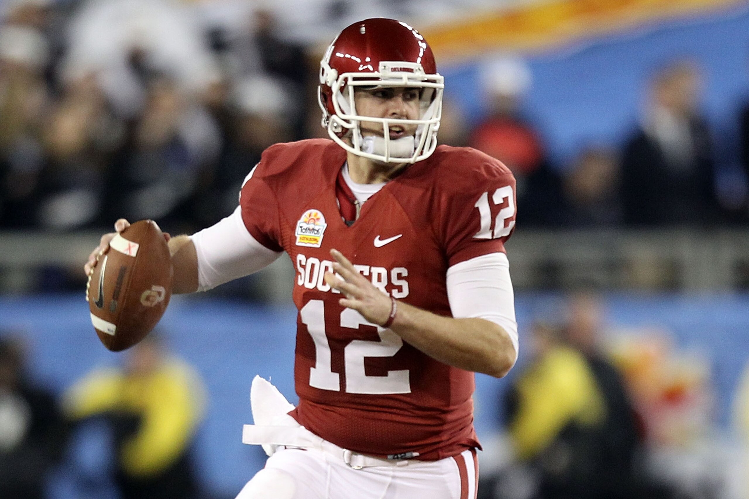 GLENDALE, AZ - JANUARY 01:  Landry Jones #12 of the Oklahoma Sooners throws the ball against the Connecticut Huskies during the Tostitos Fiesta Bowl at the Universtity of Phoenix Stadium on January 1, 2011 in Glendale, Arizona.  (Photo by Christian Peters