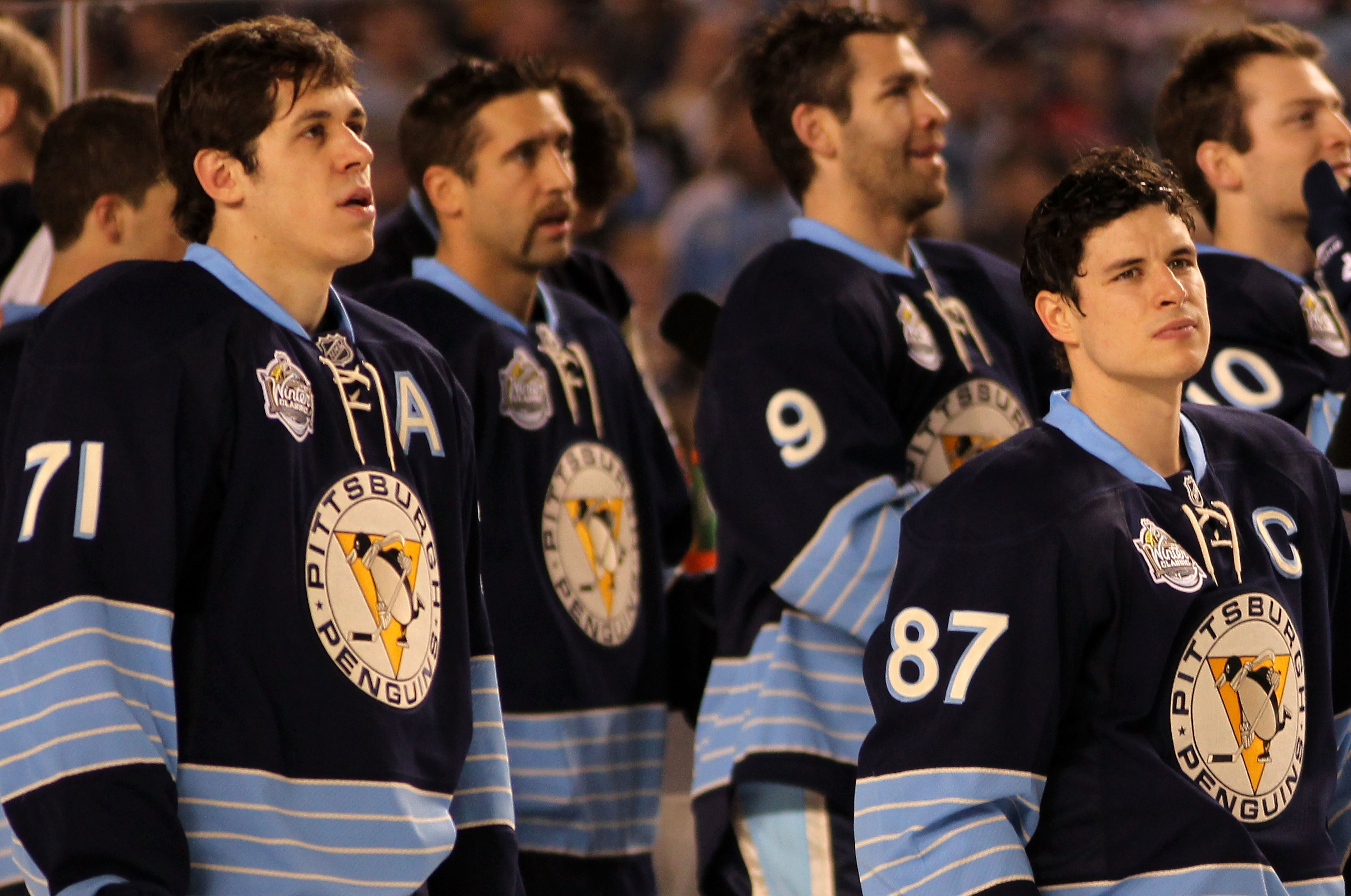 PITTSBURGH, PA - JANUARY 01:  Evgeni Malkin #71 and Sidney Crosby #87 of the Pittsburgh Penguins look on during the singing of the national anthem before playing against the Washington Capitals in the 2011 NHL Bridgestone Winter Classic at Heinz Field on