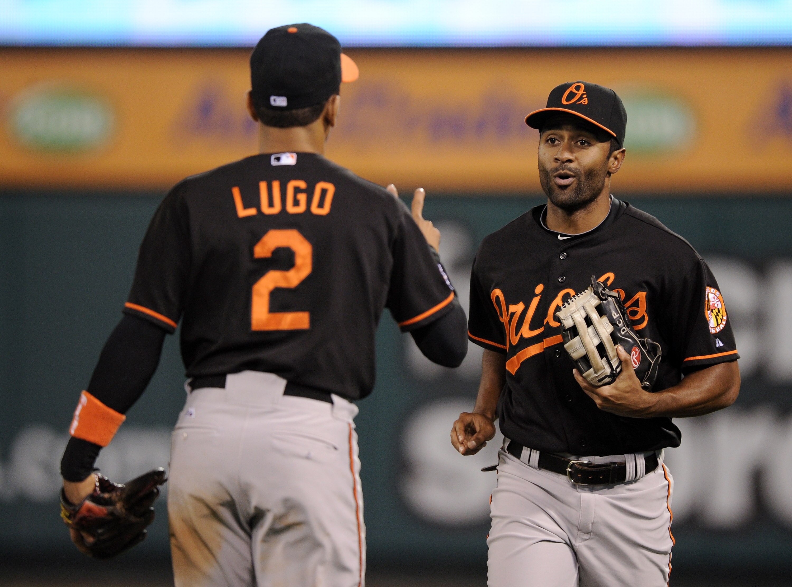 ANAHEIM, CA - AUGUST 27:  Corey Patterson #6 of the Baltimore Orioles reacts to Julio Lugo #2 after his catch at the wall off the bat of Mike Napoli #44 of the Los Angeles Angels of Anaheim during the fifth inning on August 27, 2010 in Anaheim, California