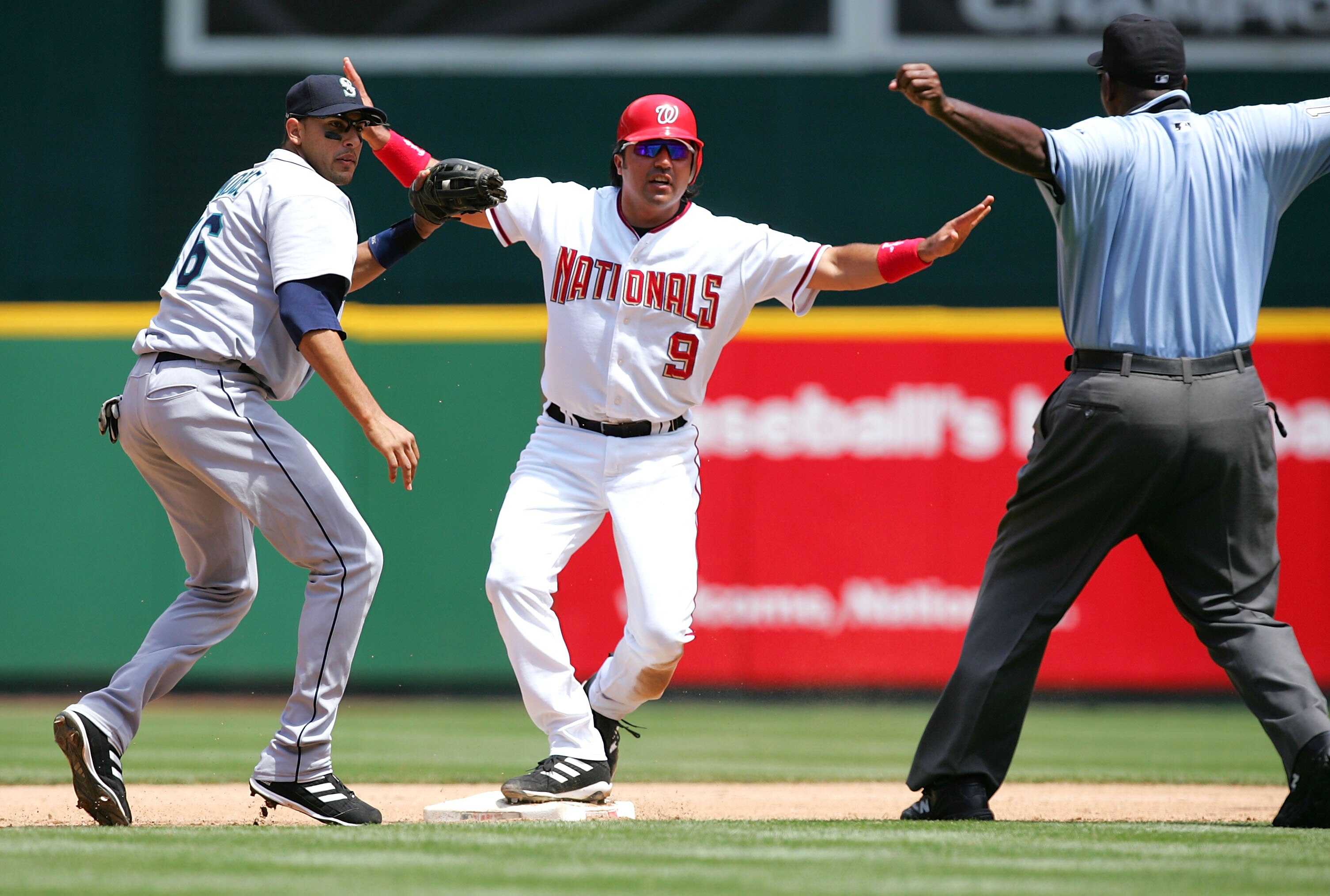 WASHINGTON - JUNE 12:  Vinny Castilla #9 of the Washington Nationals is called safe after stealing second base as shortstop Mike Morse #46 of the Seattle Mariners applies the tag on June 12, 2005 at RFK Stadium in Washington, DC.  (Photo By Jamie Squire/G