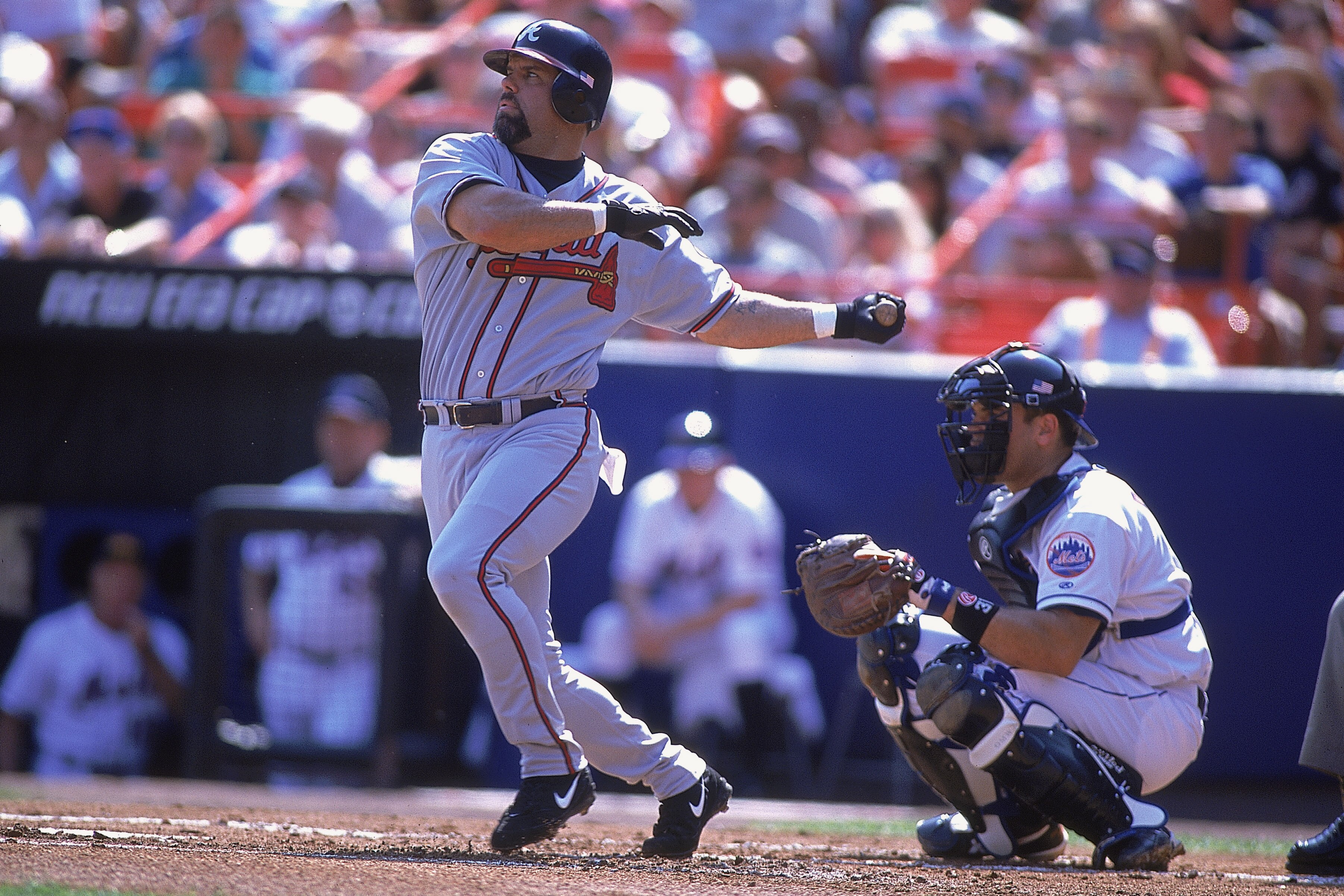 23 Sep 2001:  Third baseman Ken Caminiti #11 of the Atlanta Braves swings while cather Mike Piazza #31 of the New York Mets crouches behind the plate during the Major League Baseball game at Shea Stadium in Flushing, New York.  The Braves came from behind