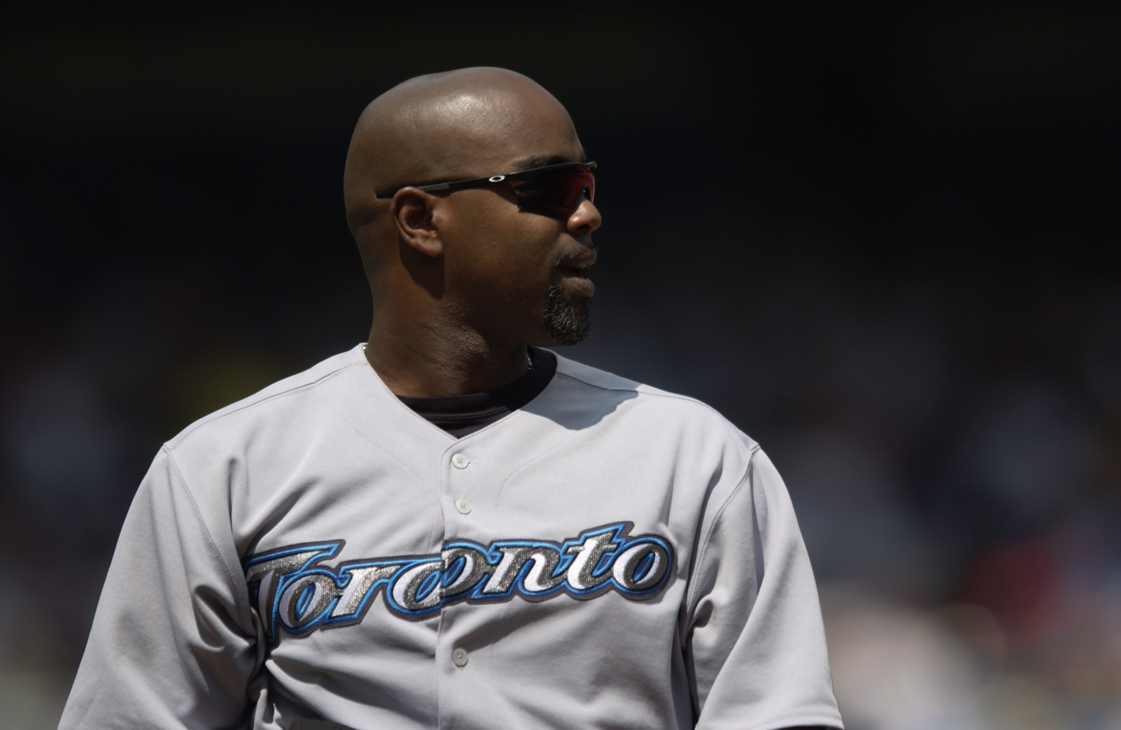 NEW YORK - AUGUST 9:  First baseman Carlos Delgado #25 of the Toronto Blue Jays watches the game against the New York Yankees at Yankee Stadium on August 9, 2004 in the Bronx, New York. The won Blue Jays won 5-4.  (Photo by M. David Leeds/Getty Images)