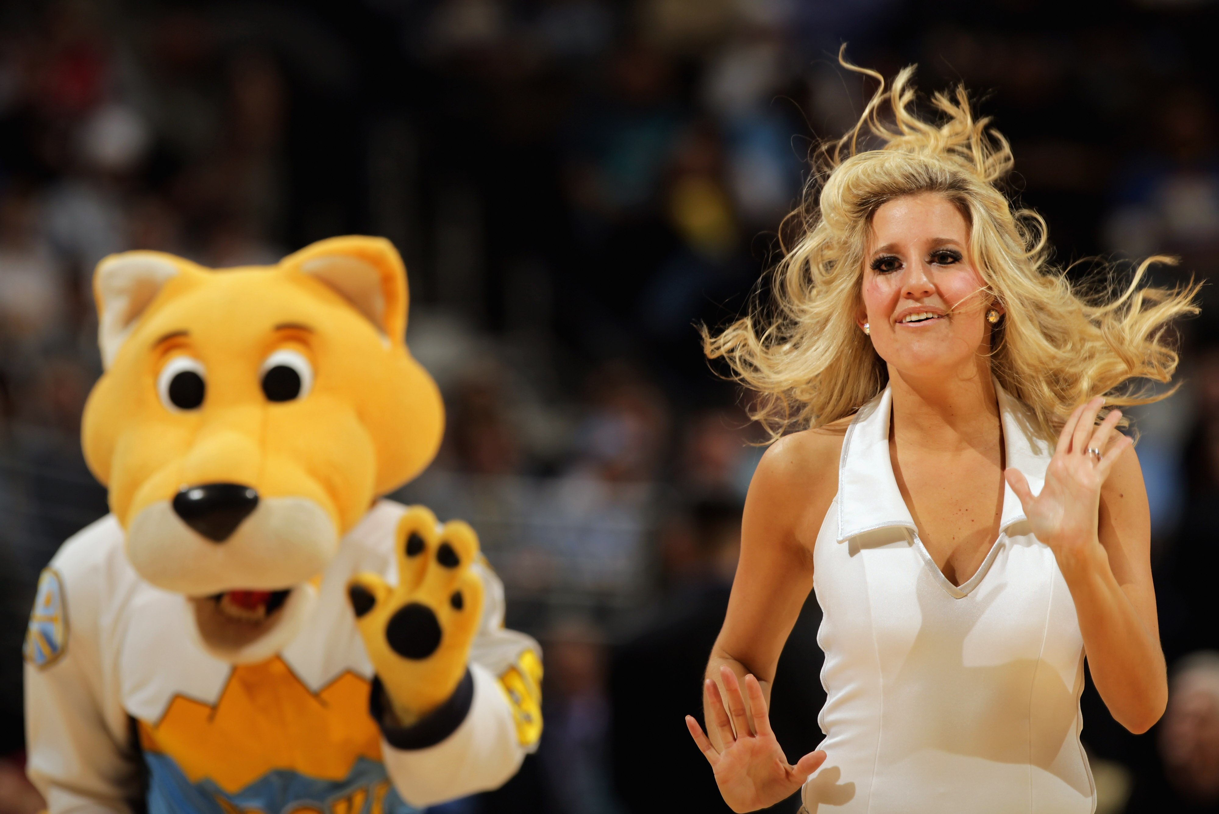 DENVER, CO - FEBRUARY 10:  Rocky, the mascot of the Denver Nuggets, performs with the Denver Nuggets Dance Team during a break in the action against the Dallas Mavericks during NBA action at the Pepsi Center on February 10, 2011 in Denver, Colorado. The N