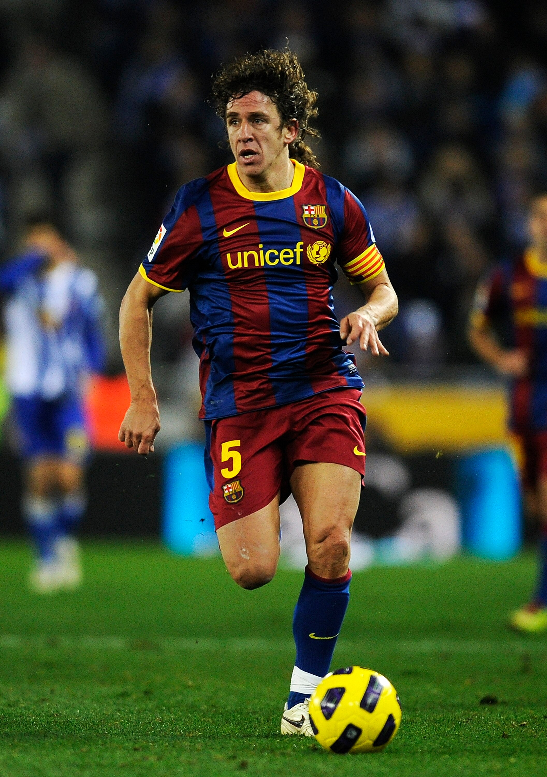 BARCELONA, SPAIN - DECEMBER 18:  Carles Puyol of Barcelona runs with the ball during the La Liga match between Espanyol and Barcelona at Cornella - El Prat stadium on December 18, 2010 in Barcelona, Spain. Barcelona won the match 1-5.  (Photo by David Ram