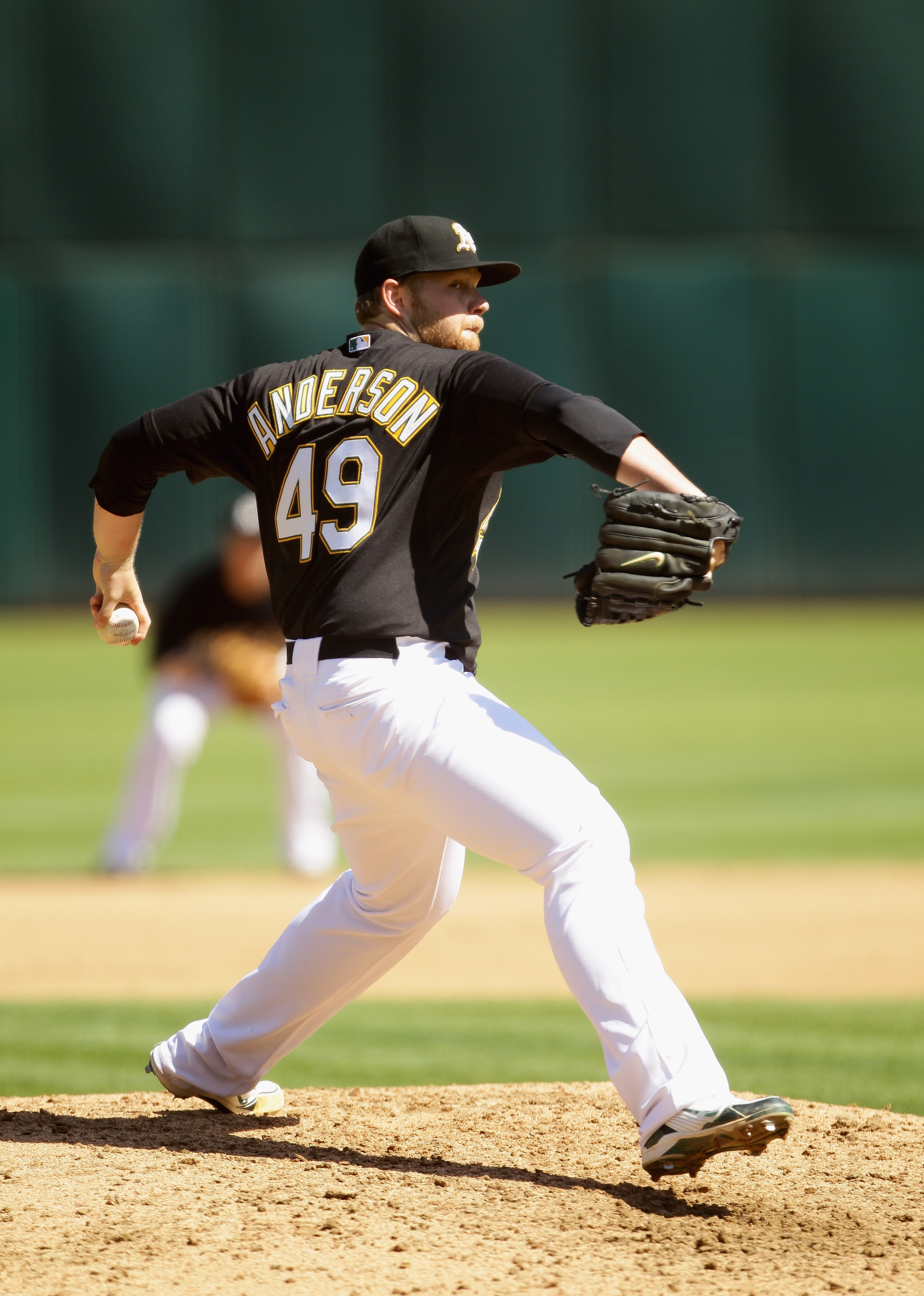 OAKLAND, CA - SEPTEMBER 22:  Brett Anderson #49 of the Oakland Athletics pitches against the Chicago White Sox at the Oakland-Alameda County Coliseum on September 22, 2010 in Oakland, California.  (Photo by Ezra Shaw/Getty Images)