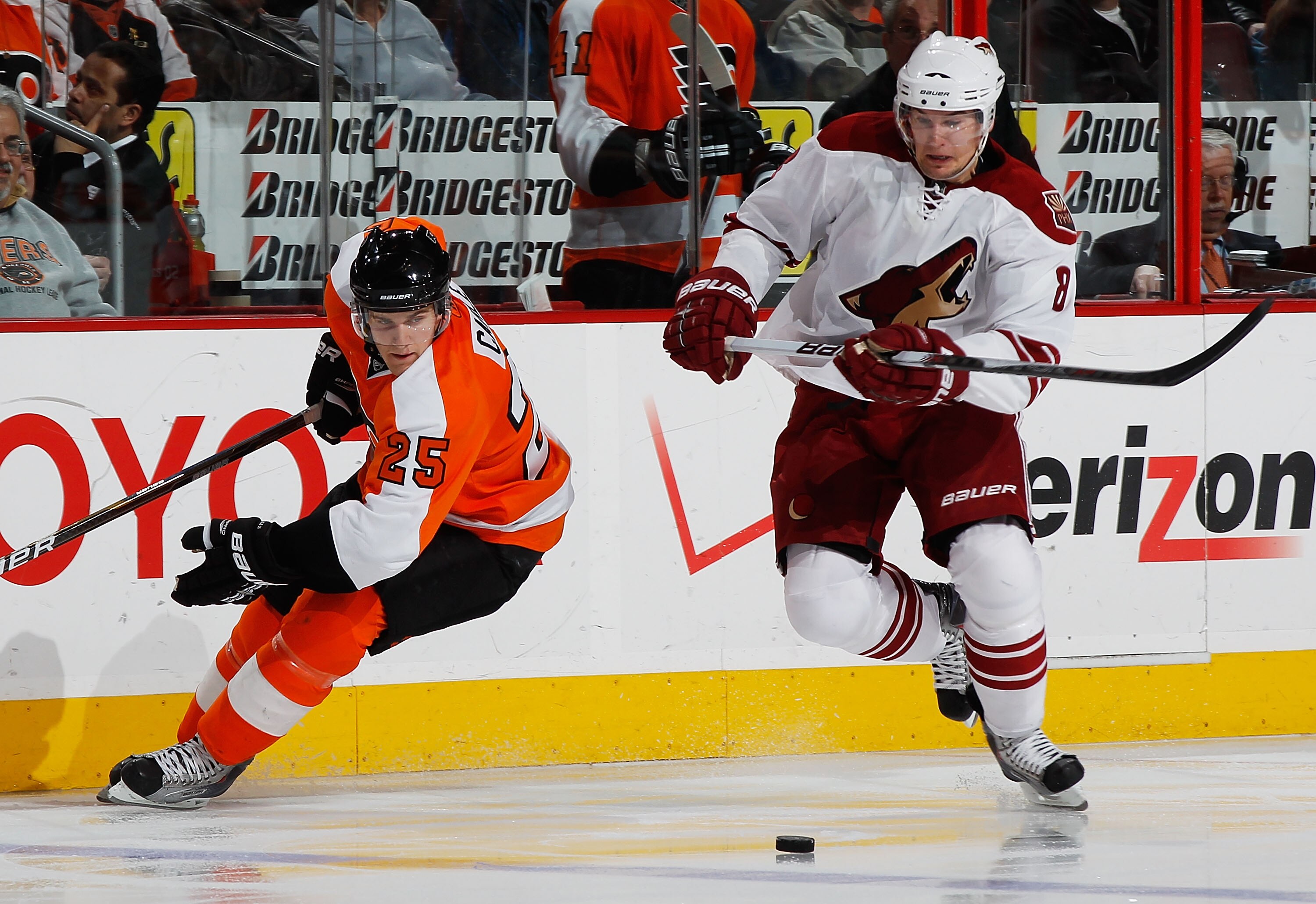 PHILADELPHIA - FEBRUARY 22:  Scottie Upshall #8 of the Phoenix Coyotes plays the puck against Matt Carle #8 of the Philadelphia Flyers on February 22, 2011 at the Wells Fargo Center in Philadelphia, Pennsylvania. Coyotes defeat the Flyers 3-2 in OT. (Phot