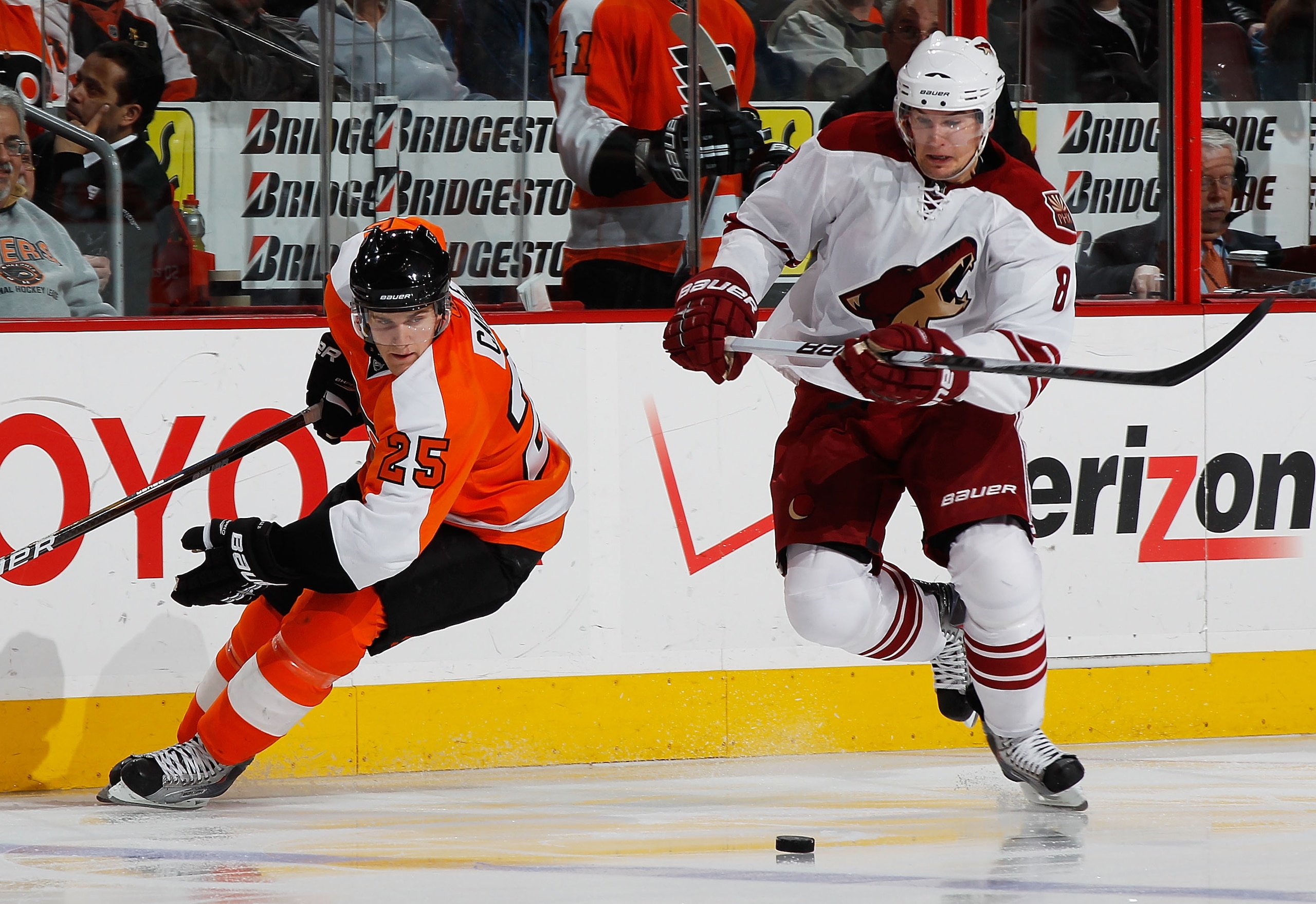 PHILADELPHIA - FEBRUARY 22:  Scottie Upshall #8 of the Phoenix Coyotes plays the puck against Matt Carle #8 of the Philadelphia Flyers on February 22, 2011 at the Wells Fargo Center in Philadelphia, Pennsylvania. Coyotes defeat the Flyers 3-2 in OT. (Phot