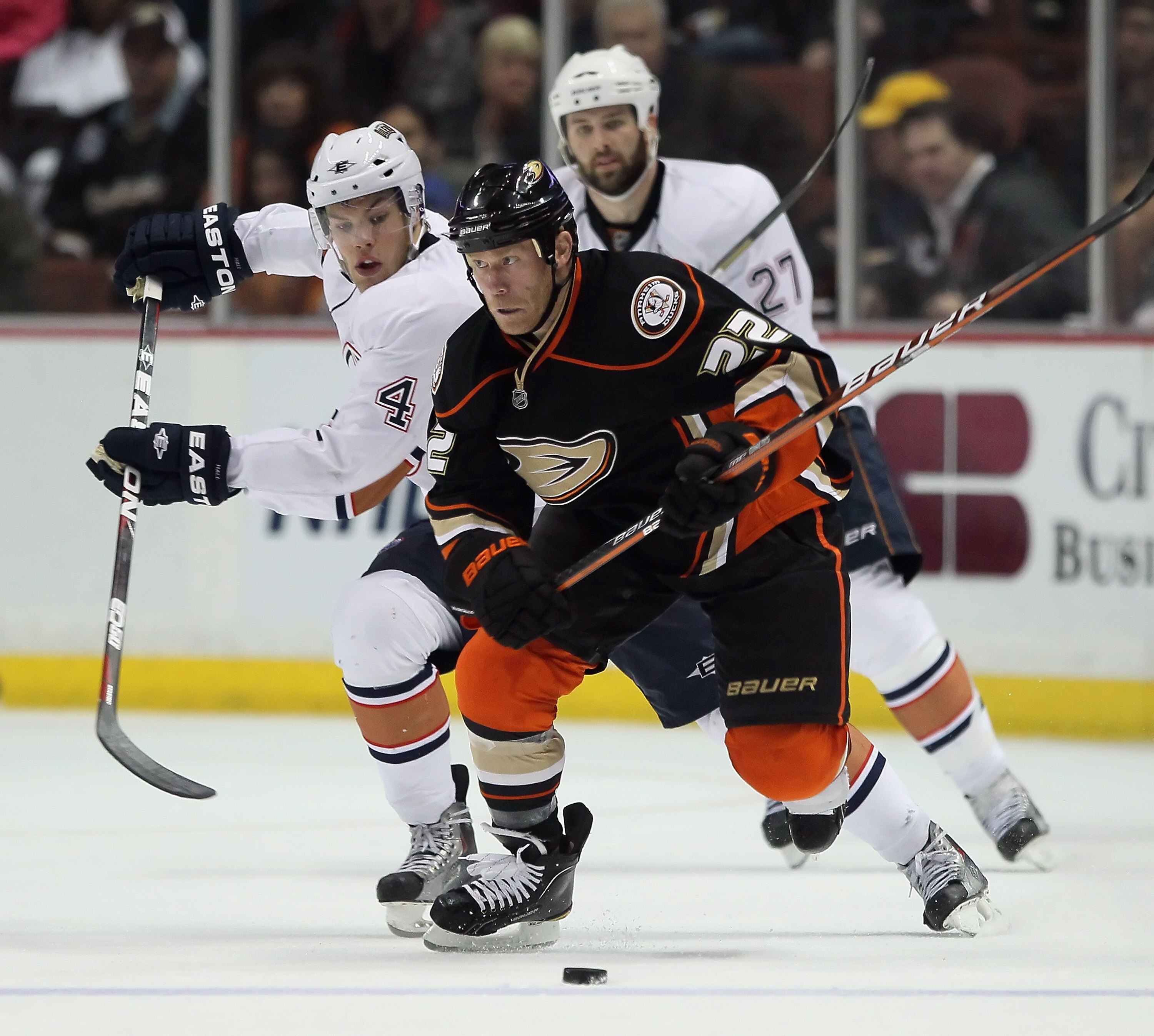ANAHEIM, CA - JANUARY 16:  Taylor Hall #4 of the Edmonton Oilers and Todd Marchant #22 of the Anaheim Ducks battle for the puck at the Honda Center on January 16, 2011 in Anaheim, California. The Ducks defeated the Oilers 3-2.  (Photo by Jeff Gross/Getty