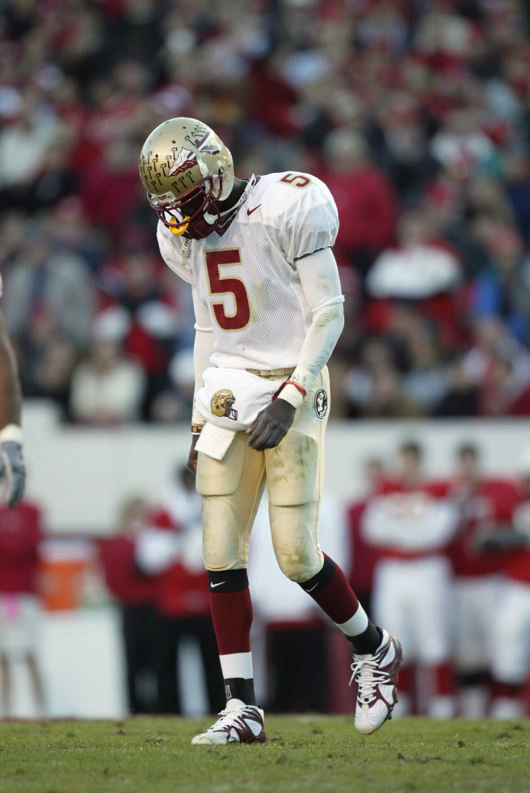 RALEIGH, NC - NOVEMBER 23:  Quarterback Adrian McPherson #5 the Florida State University Seminoles walks to the sidelines dejected during the Atlantic Coast Conference NCAA game against the North Carolina State University Wolfpack at Carter-Finley Stadium