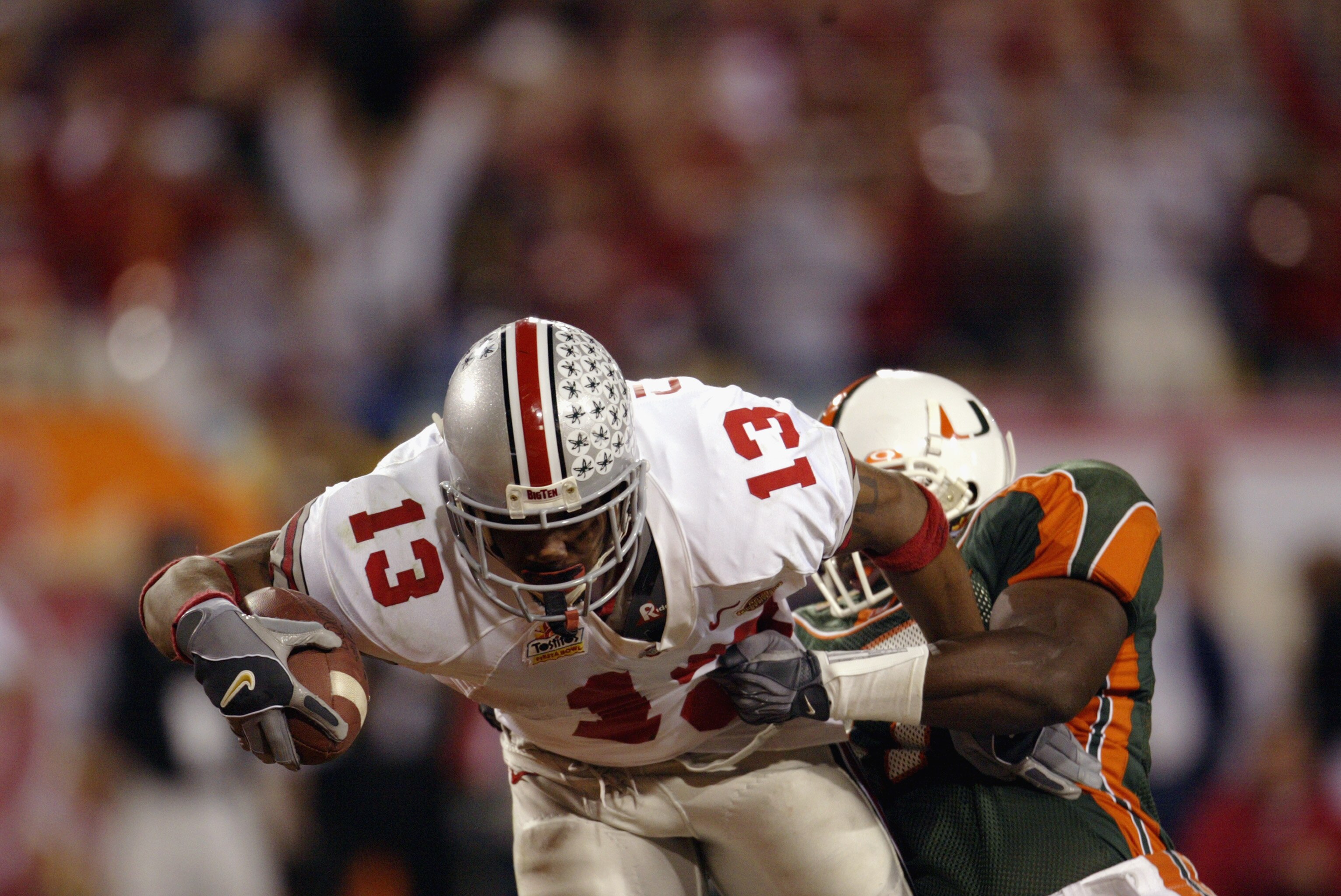 TEMPE, AZ - JANUARY 3:  Running back Maurice Clarett #13 of the Ohio State Buckeyes lunges for the goaline to score the team's second touchdown against the University of Miami Hurricanes during the Tostitos Fiesta Bowl at Sun Devil Stadium on January 3, 2