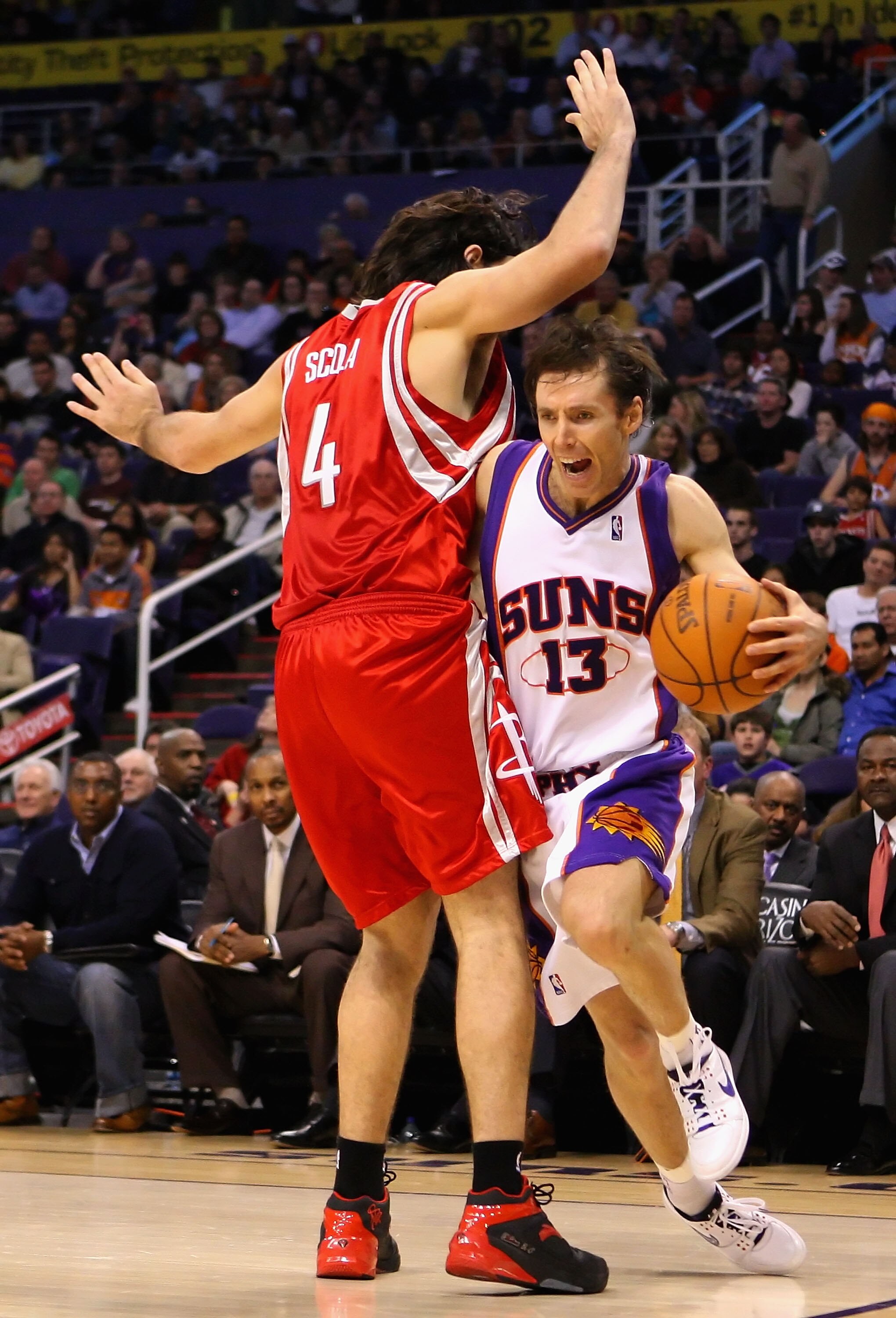 PHOENIX - JANUARY 06:  Steve Nash #13 of the Phoenix Suns attempts to drive the ball against Luis Scola #4 of the Houston Rockets during the NBA game at US Airways Center on January 6, 2010 in Phoenix, Arizona. The Suns defeated the Rockets 118-110. NOTE
